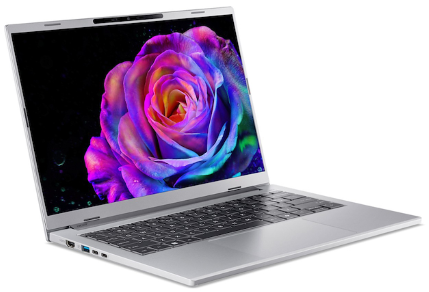 Laptop plateado que muestra una rosa vibrante y colorida en su pantalla. Teclado visible. Fondo negro. Superficie blanca.