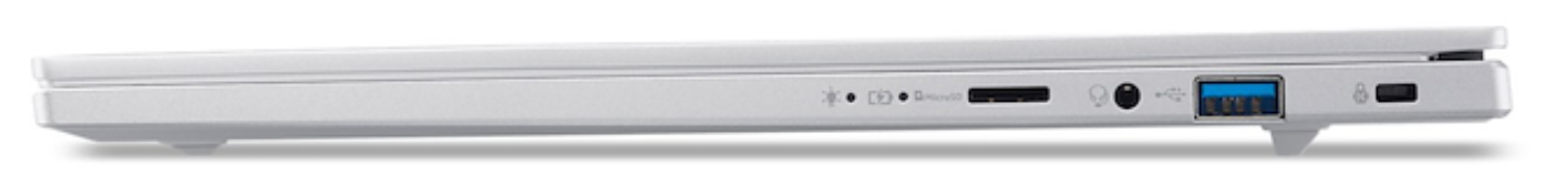 Vista lateral de una laptop blanca con puertos: USB, audio, carga y bloqueo de seguridad. Una sombra está debajo de la laptop.