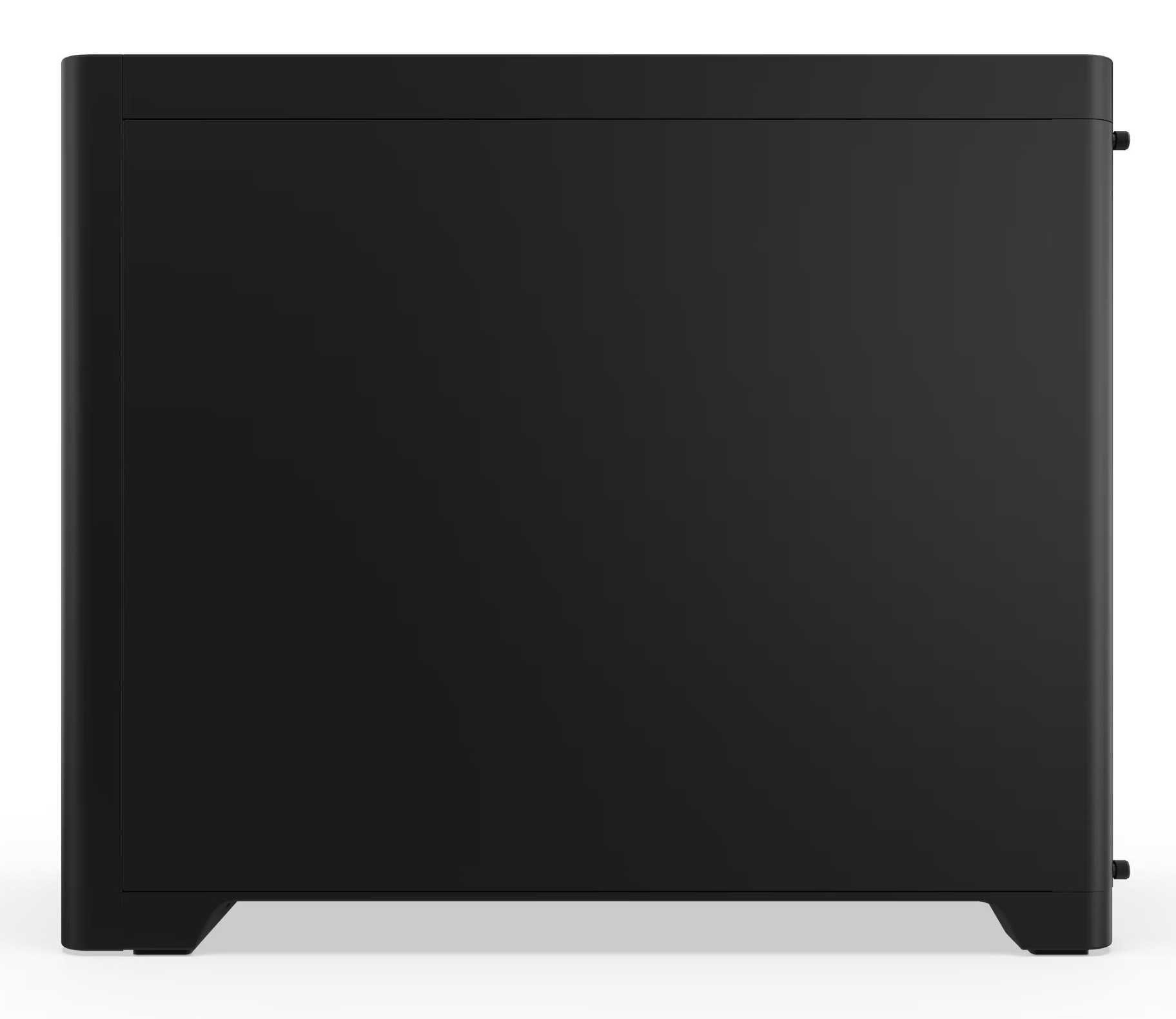 Czarny, prostokątny obiekt o gładkiej powierzchni, prawdopodobnie szafka lub urządzenie, stoi na białej powierzchni.