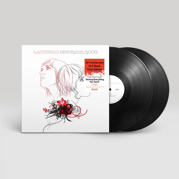 Albumcover mit zwei schwarzen Schallplatten. Das Cover zeigt ein Frauenprofil, rote Akzente und Text, darunter 'Ladytron' und '20th Anniversary'.
