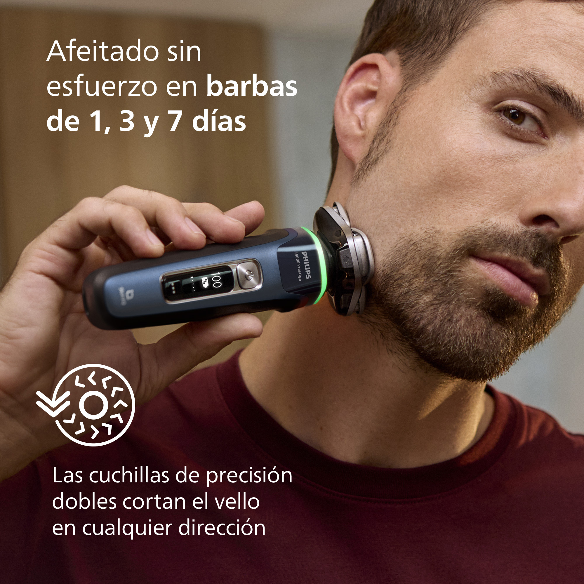 Un hombre se afeita con una afeitadora Philips. La afeitadora es azul y negra, con una pantalla digital. Texto en la imagen.