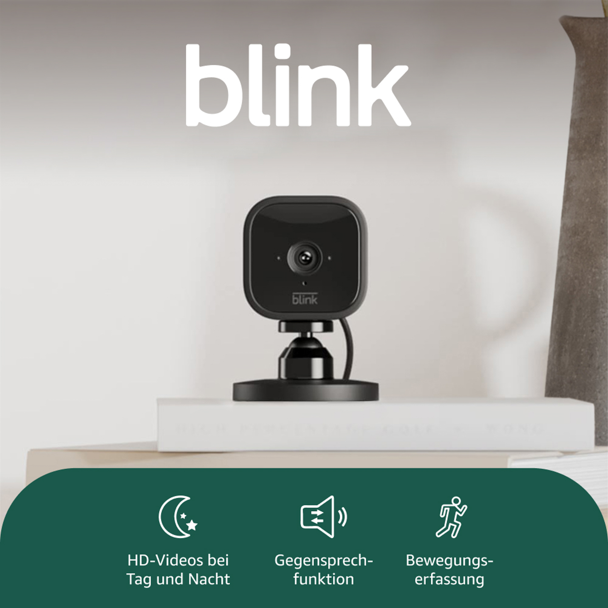 Schwarze Blink-Überwachungskamera auf einem Ständer. Das Wort 'blink' steht darüber. Merkmale: HD-Videos, Zwei-Wege-Audio, Bewegungserkennung.