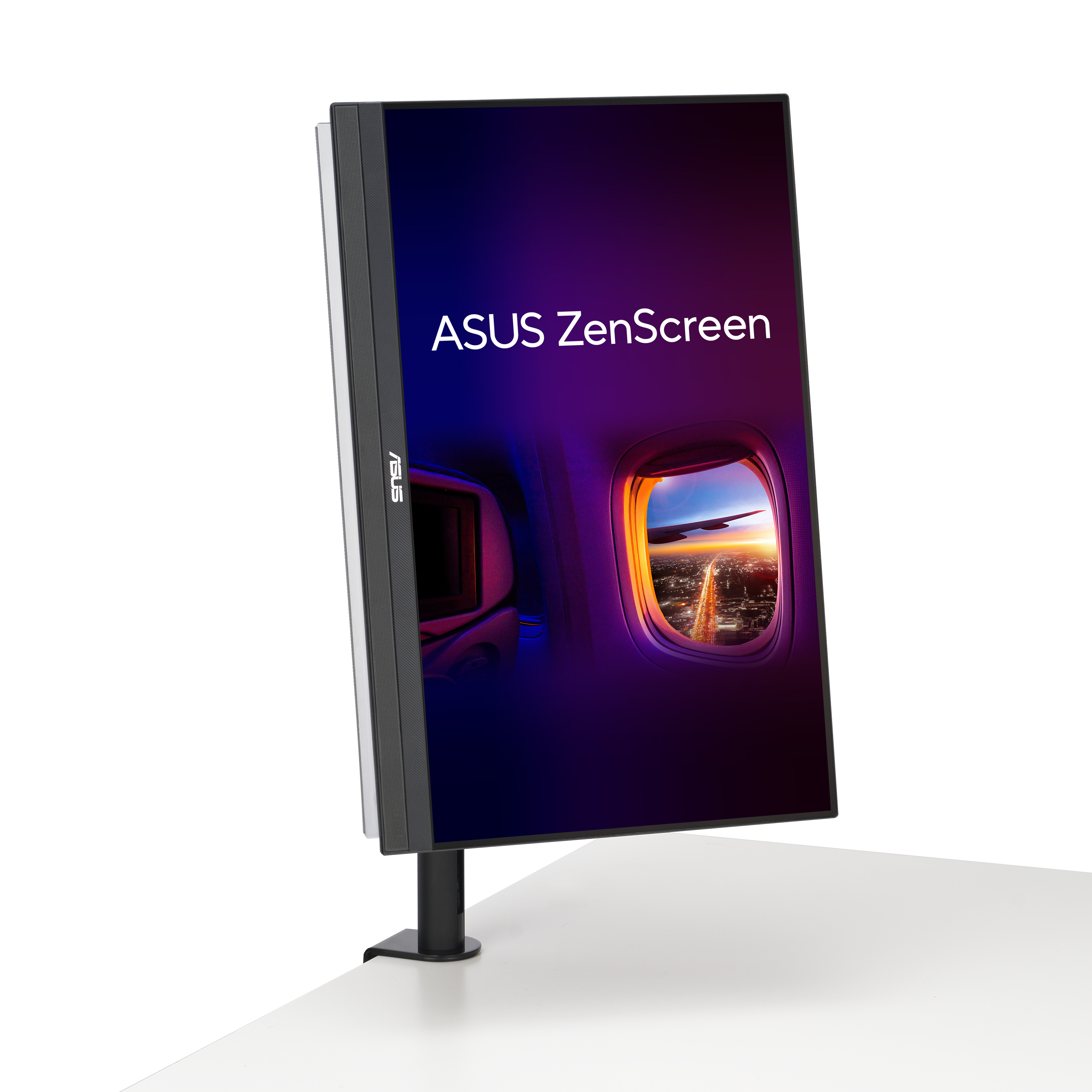 ASUS ZenScreen monitor. A képernyő egy repülőgép ablakából látható kilátást mutat naplementével a város felett.