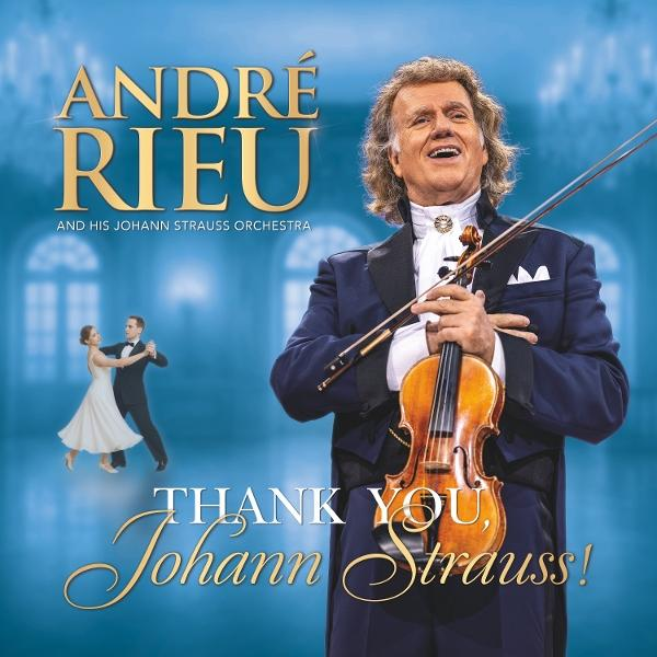 André Rieu mit Geige, lächelnd. Titel: 'Thank You, Johann Strauss!' Ein Paar tanzt im Hintergrund.