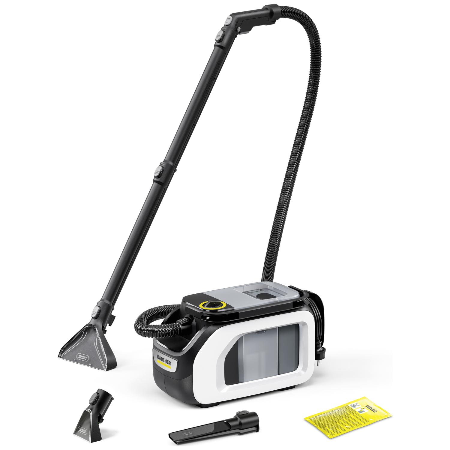 Een Karcher tapijtreiniger. De hoofdeenheid is zwart, wit en grijs. Inclusief meerdere mondstukken en een gele instructieblad.