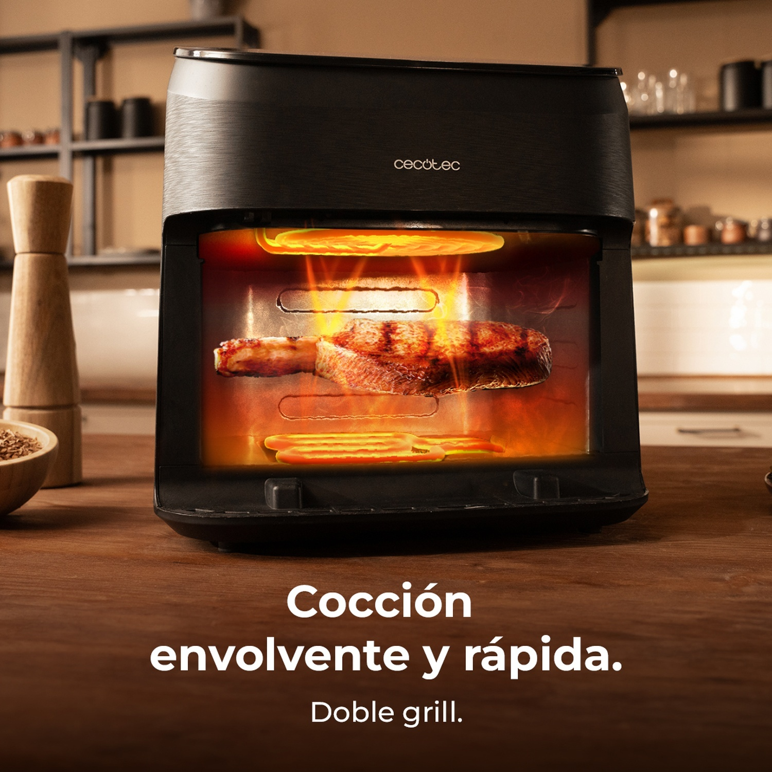 Un forno nero con bistecca dentro. Fiamme attorno alla bistecca. Tavolo di legno in primo piano. Testo: 'Cocción envolvente y rápida'.