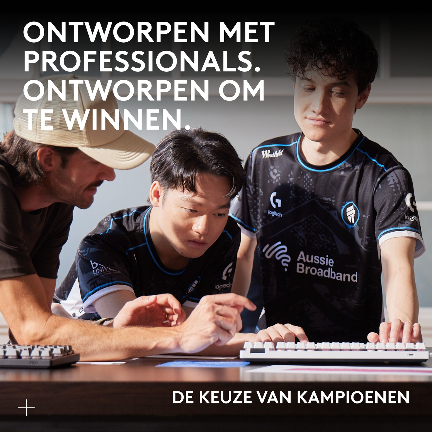 Three men looking at a keyboard. Text reads: Designed with professionals. Designed to win. The choice of champions.