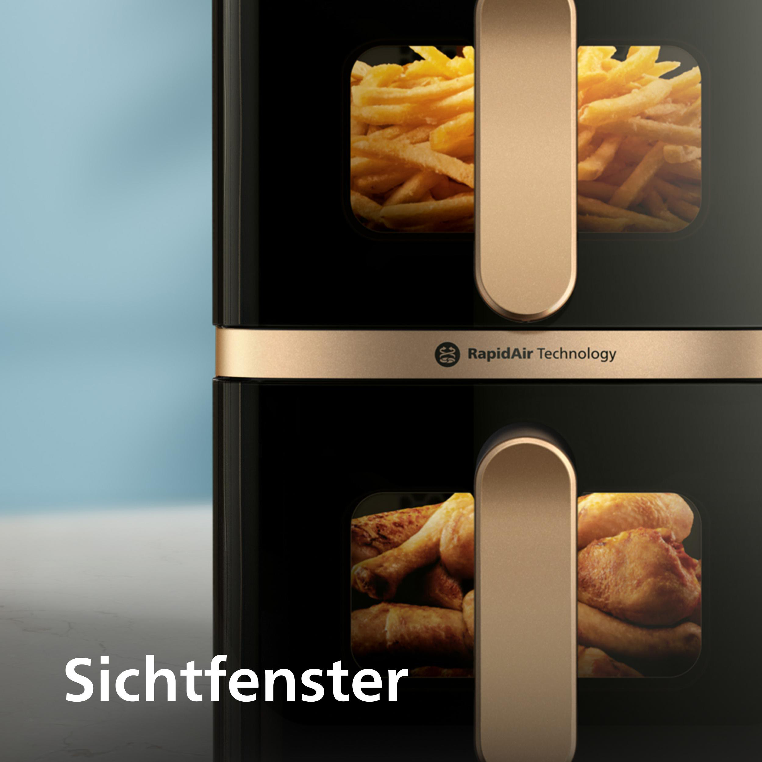 Schwarze Heißluftfritteuse mit goldenen Akzenten, die durch Fenster gebratene Speisen zeigt. Enthält Pommes und Hähnchen.