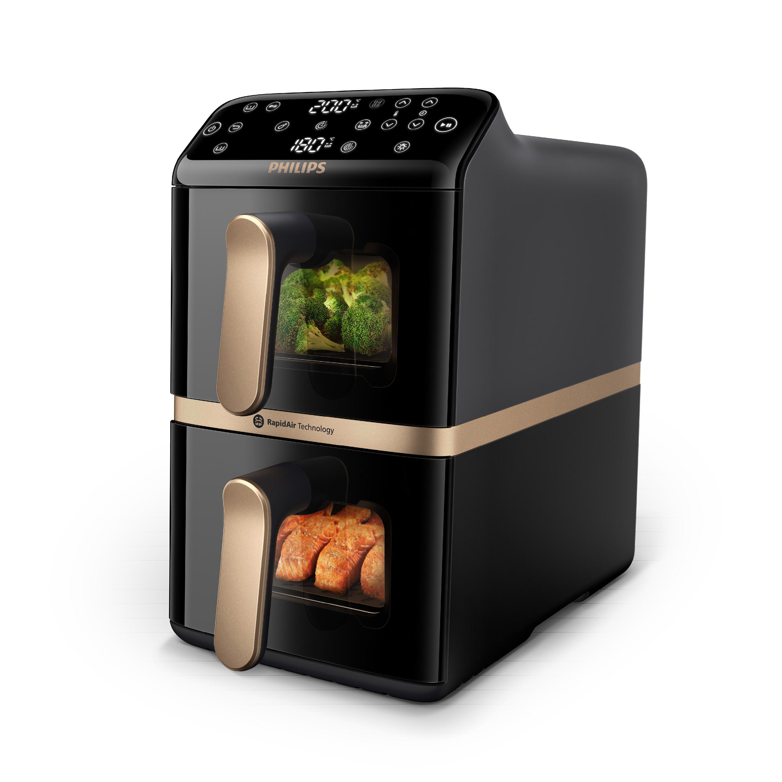 Schwarze Philips Heißluftfritteuse mit goldenen Akzenten. Zeigt die Temperatur an. Brokkoli und Lachs.