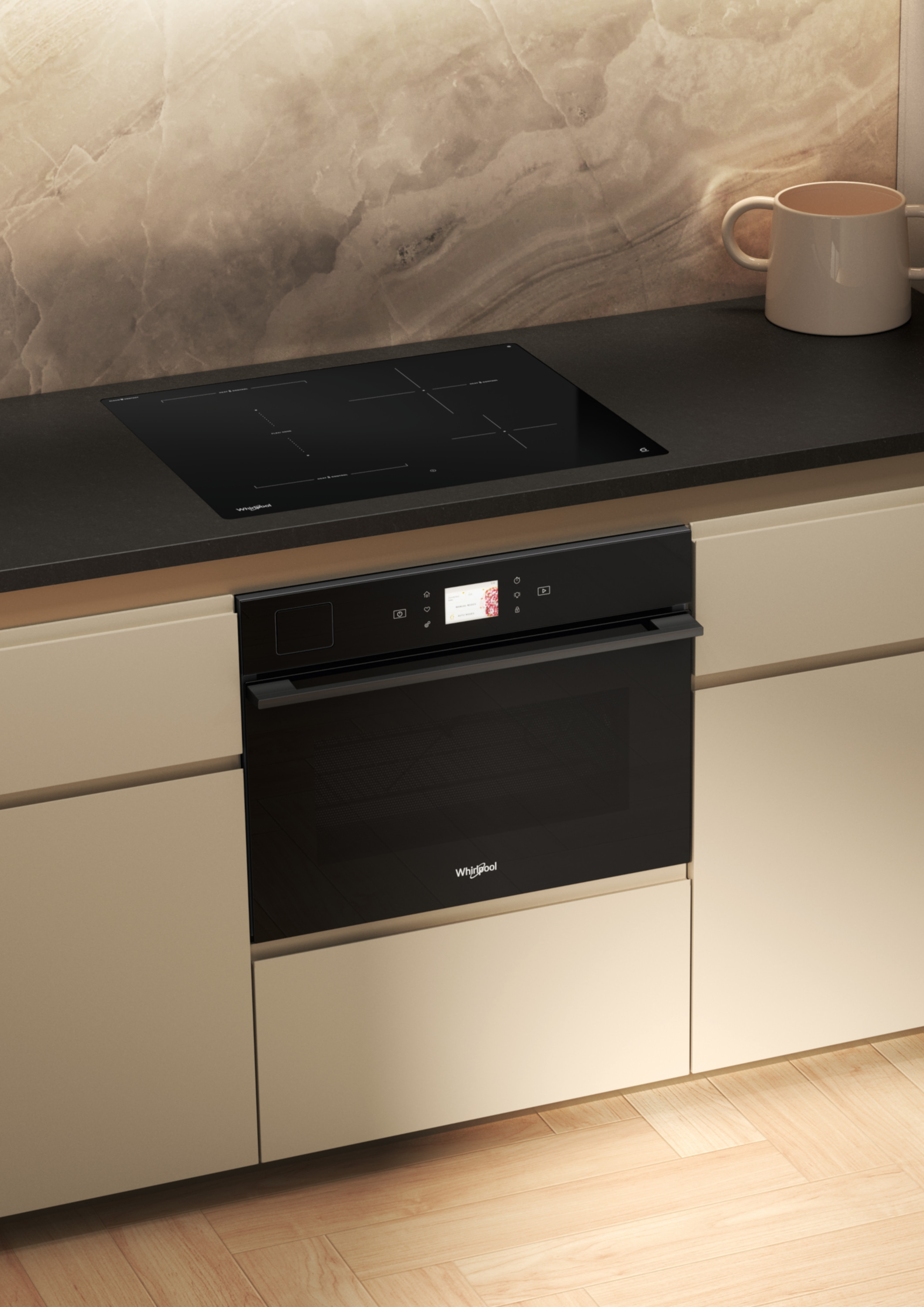 Wnętrze kuchni z czarną płytą grzejną i piekarnikiem. Beżowe szafki i marmurowa ściana. Kubek na blacie.