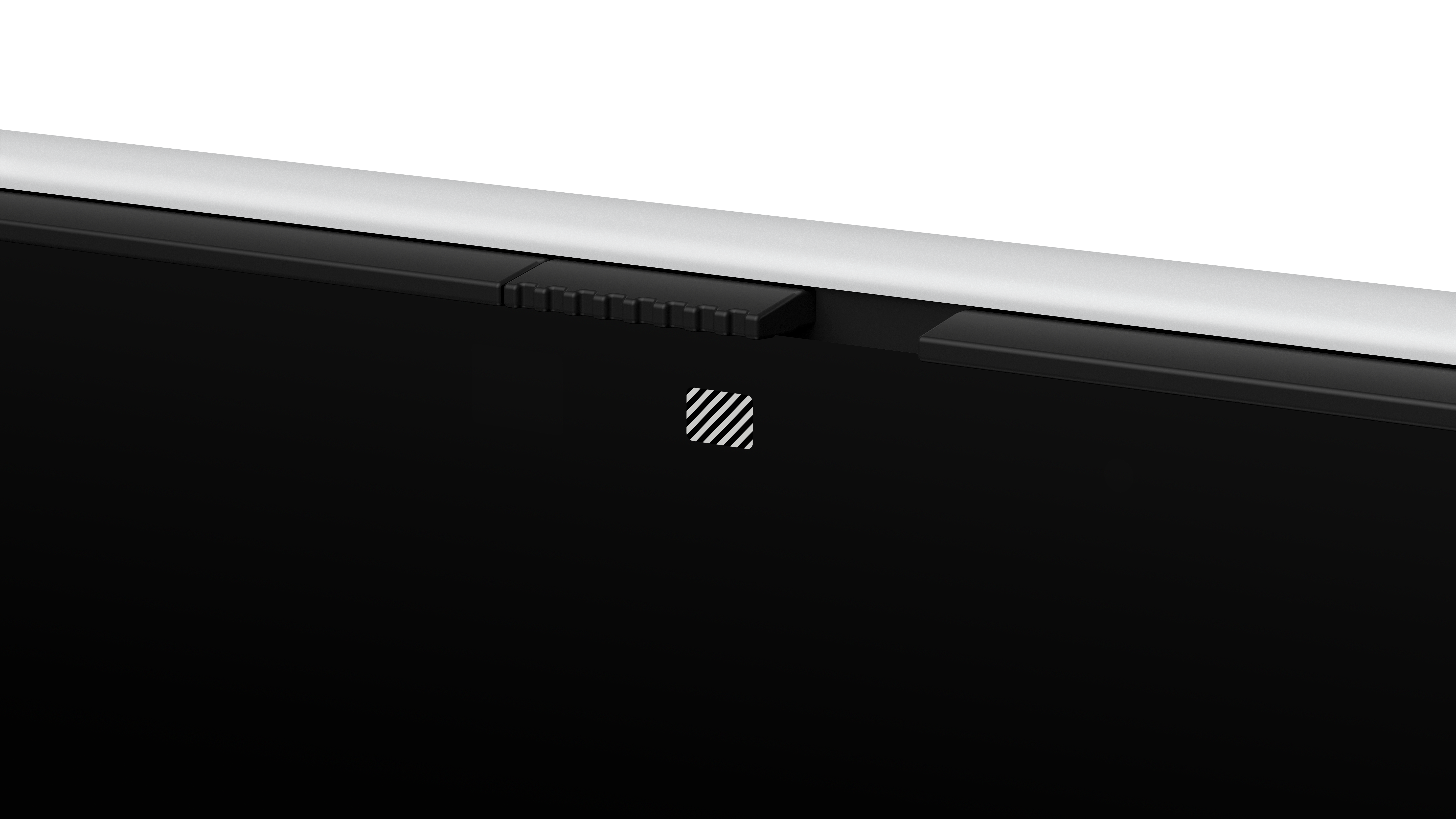 Zbliżenie czarnego urządzenia z białą górną krawędzią. Widoczny czarny, żebrowany fragment i biało-czarne logo.