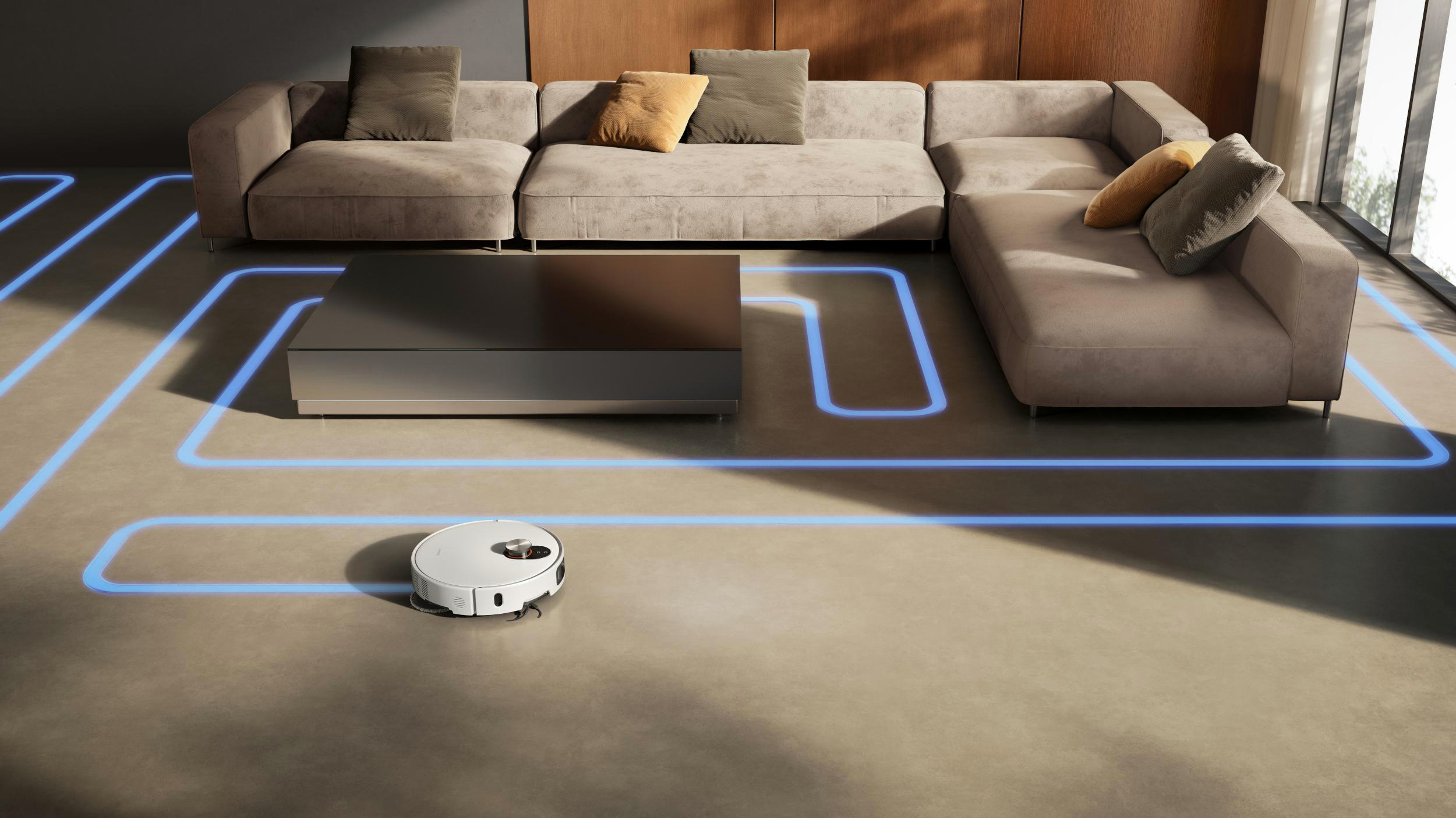 Ein Roboter-Staubsauger reinigt ein Wohnzimmer mit einem Ecksofa und einem Couchtisch. Eine blaue Lichtkarte zeigt den Reinigungsweg.