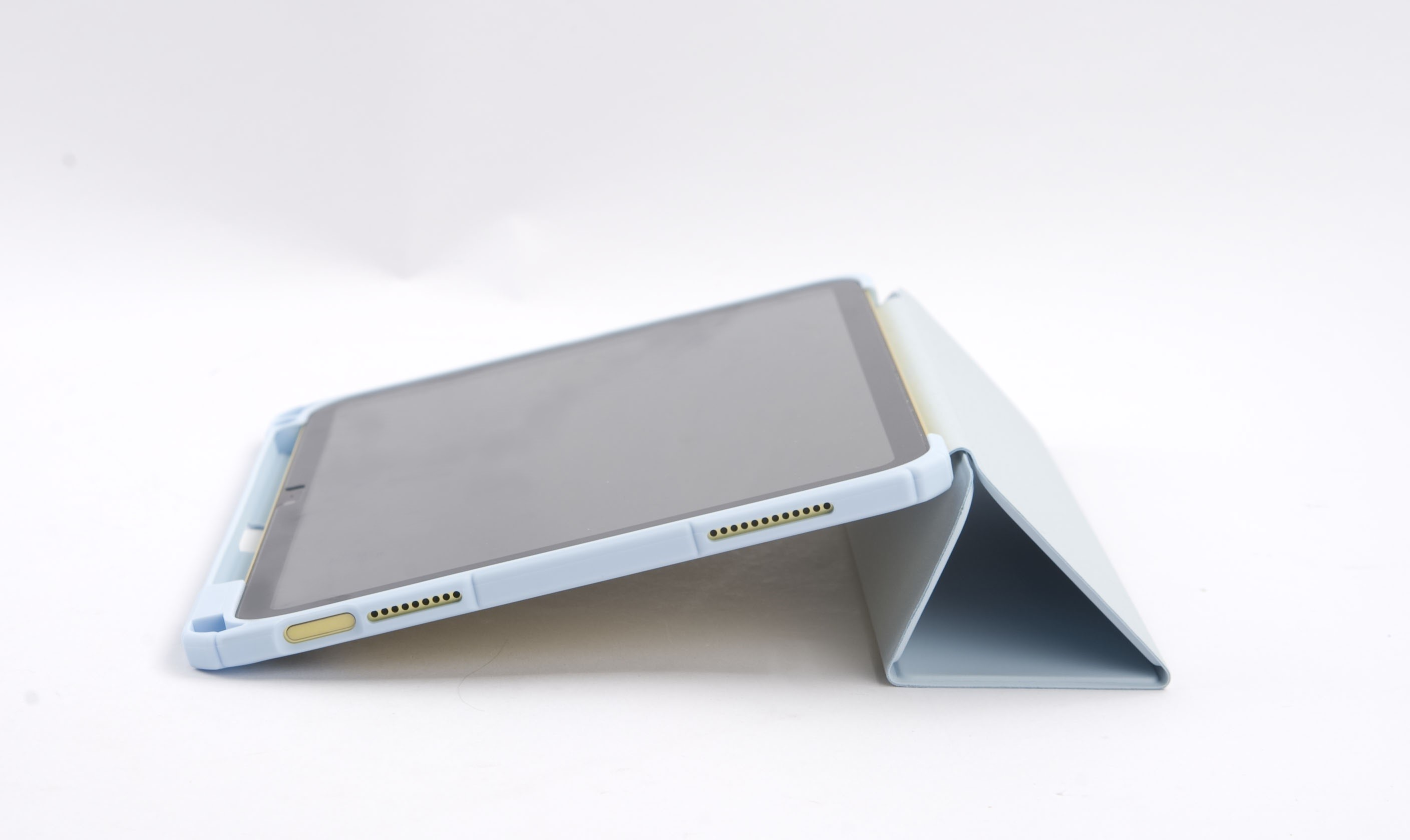 Ein hellblaues Tablet mit hellblauer Hülle liegt auf einer weißen Oberfläche. Der Tablet-Bildschirm ist dunkel.