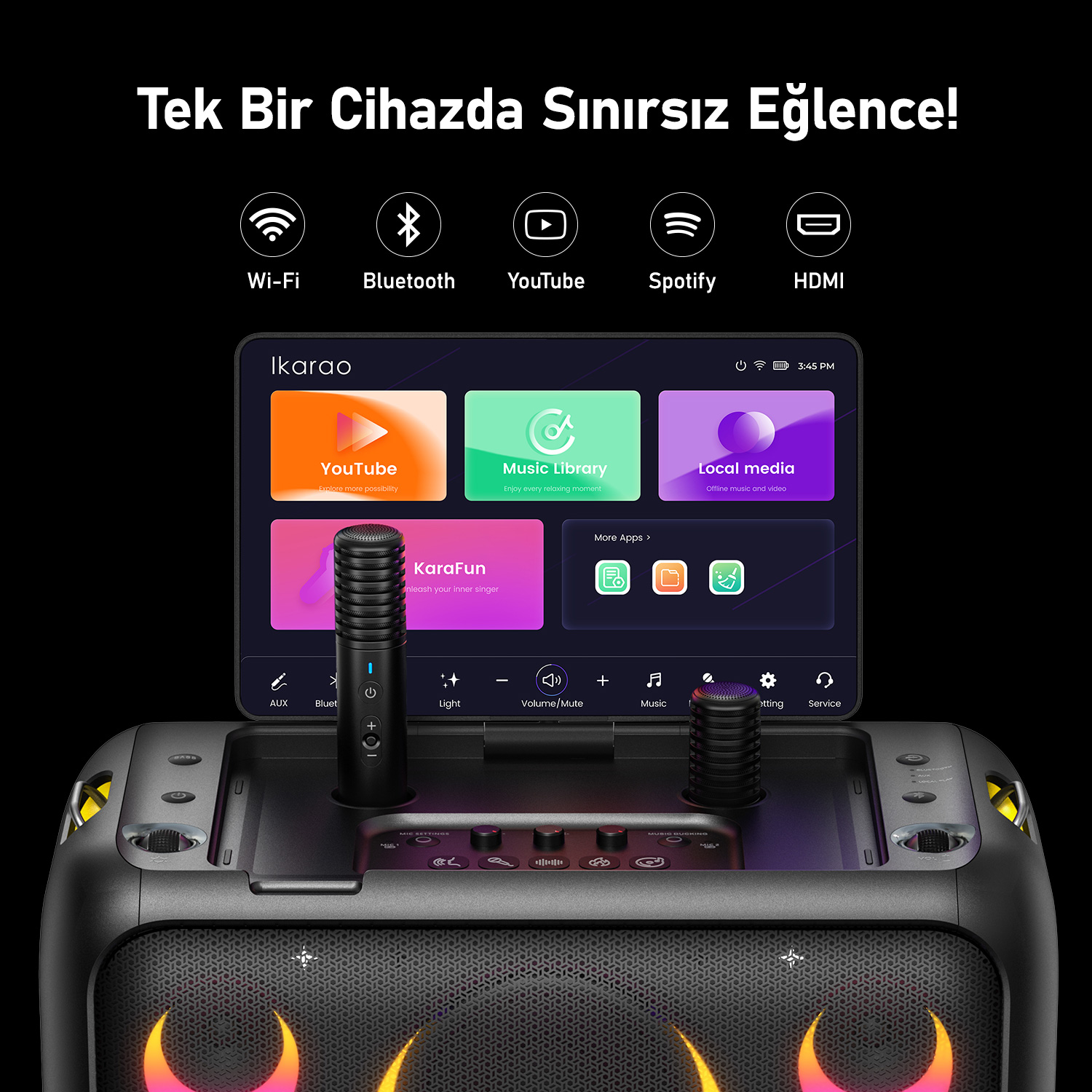 Uygulamaları gösteren bir ekranı olan siyah bir karaoke makinesi. İki mikrofon takılıdır. Makine, renkli bir tasarıma sahip bir hoparlöre sahiptir.