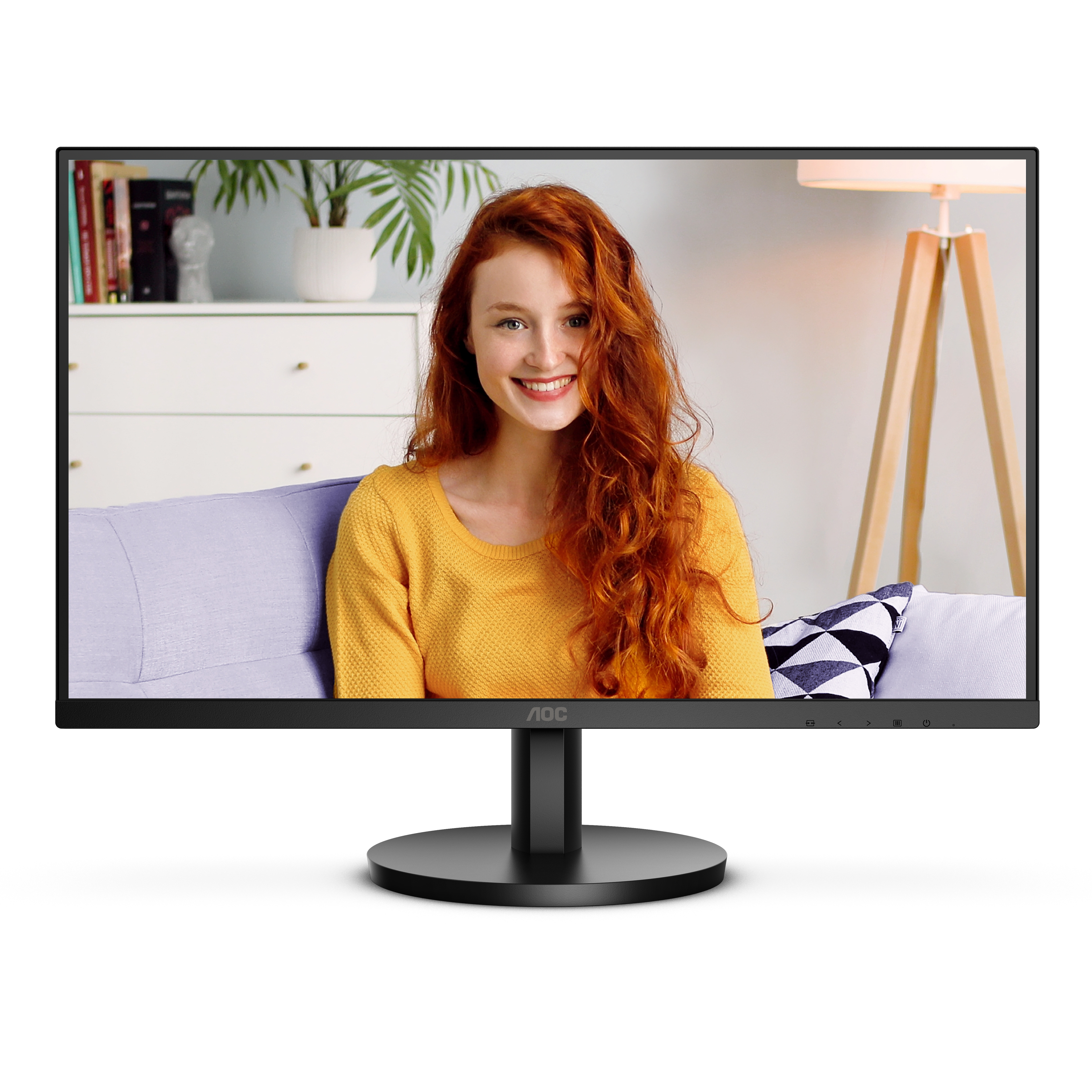 Un monitor mostra una donna dai capelli rossi che sorride. Lo sfondo mostra una stanza con un divano e una lampada.