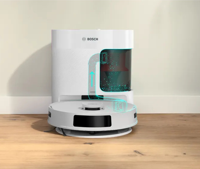Biały robot sprzątający Bosch. Ma okrągłą podstawę i wysoką, prostokątną górę. Strzałki pokazują ścieżkę czyszczenia.