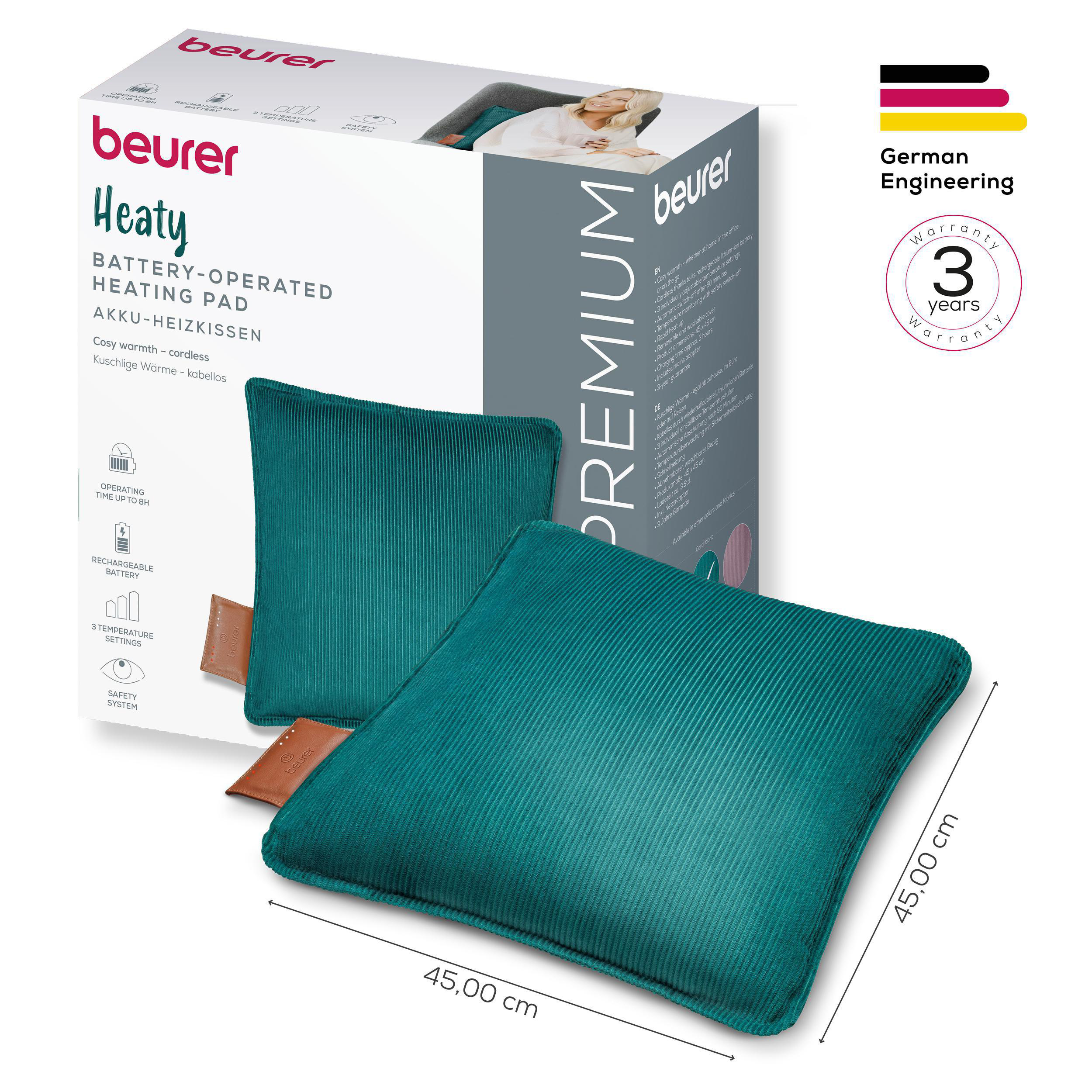 Ein türkisfarbenes Heizkissen mit braunem Anhänger, verpackt mit einer Box mit Produktinfo und der Marke Beurer.