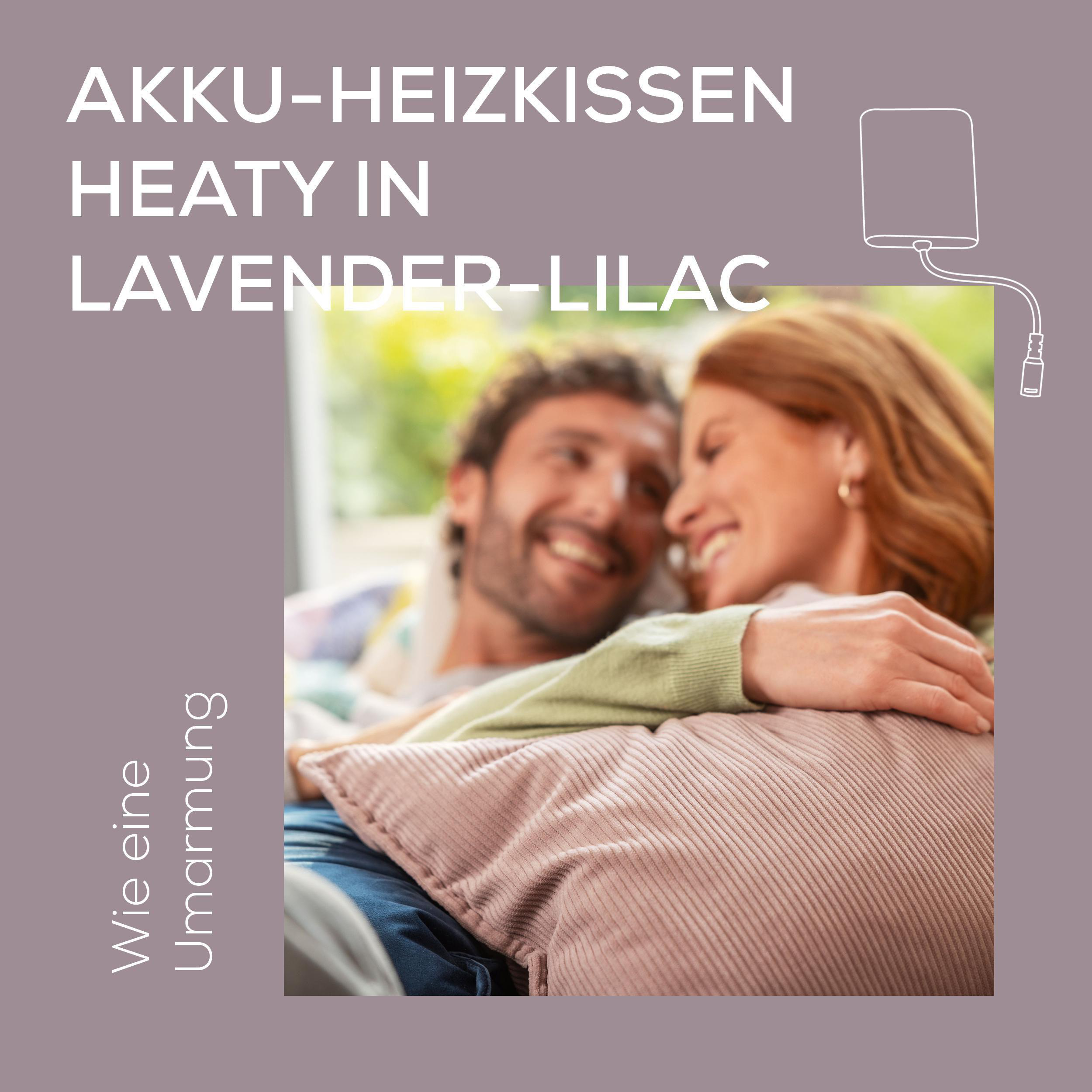 Ein Paar kuschelt und lächelt, ein Heizkissen in Lavendel-Lila. Text: AKKU-HEIZKISSEN HEATY IN LAVENDER-LILAC. Wie eine Umarmung.
