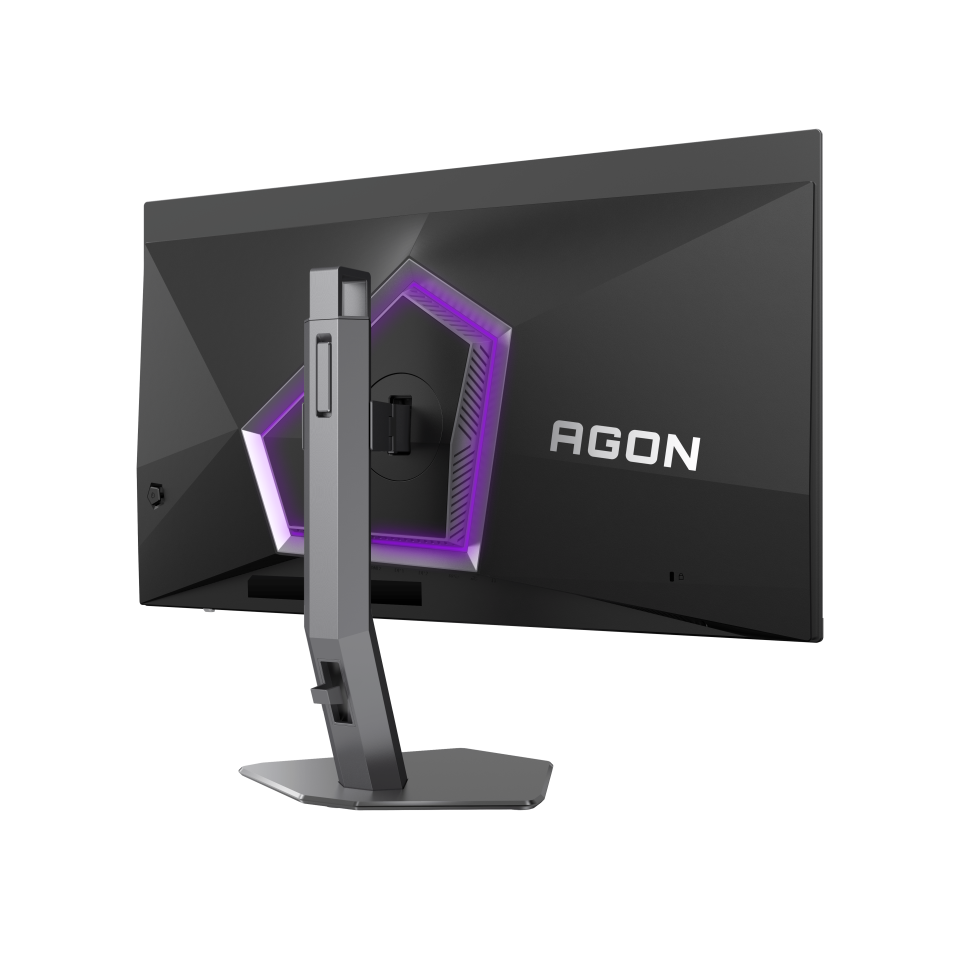 Egy fekete gamer monitor hátulról. A monitoron állvány, logó és lila fénydesign látható.