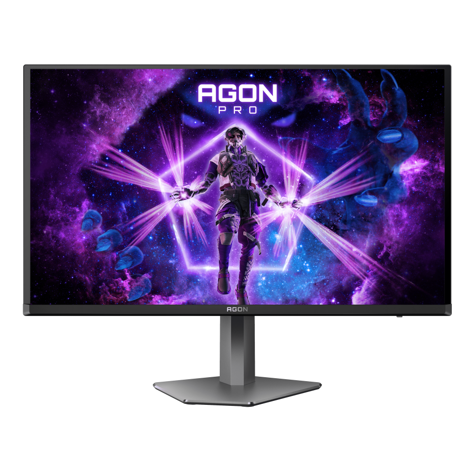 Egy számítógép monitor egy futurisztikus képet jelenít meg egy alakról, amely fényt sugároz egy kozmikus háttérben, az AGON PRO logó látható.