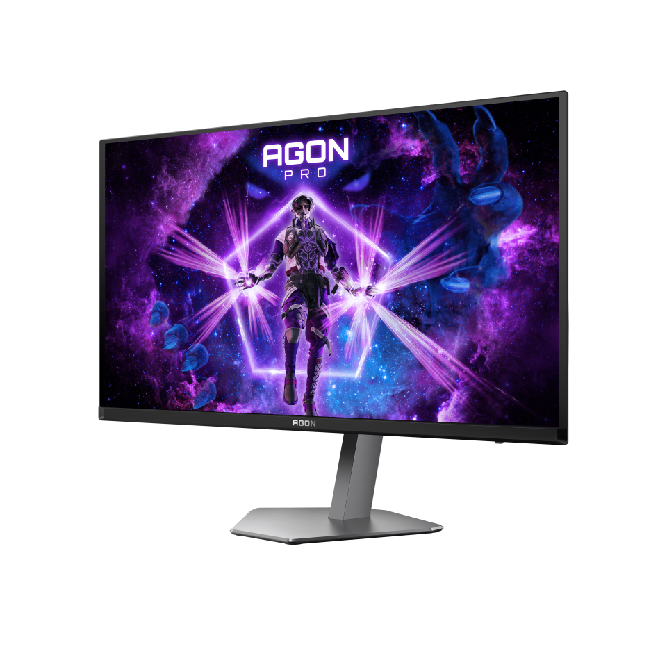 Egy gamer monitor egy futurisztikus jelenetet jelenít meg. Egy páncélozott figura a középpontban energiakötegekkel. A háttér lila galaxissal rendelkezik.
