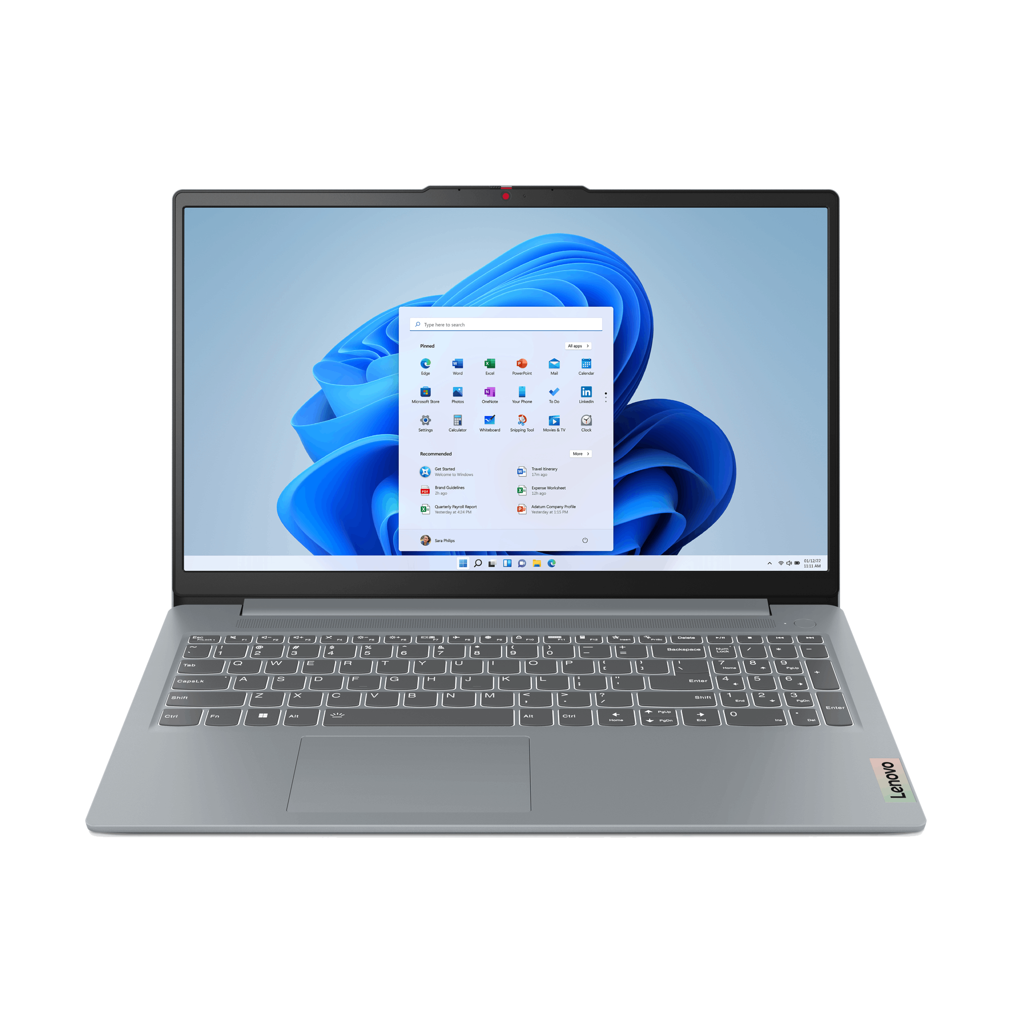 Un portátil Lenovo plateado está abierto sobre un fondo negro. La pantalla muestra el menú de inicio de Windows 11.