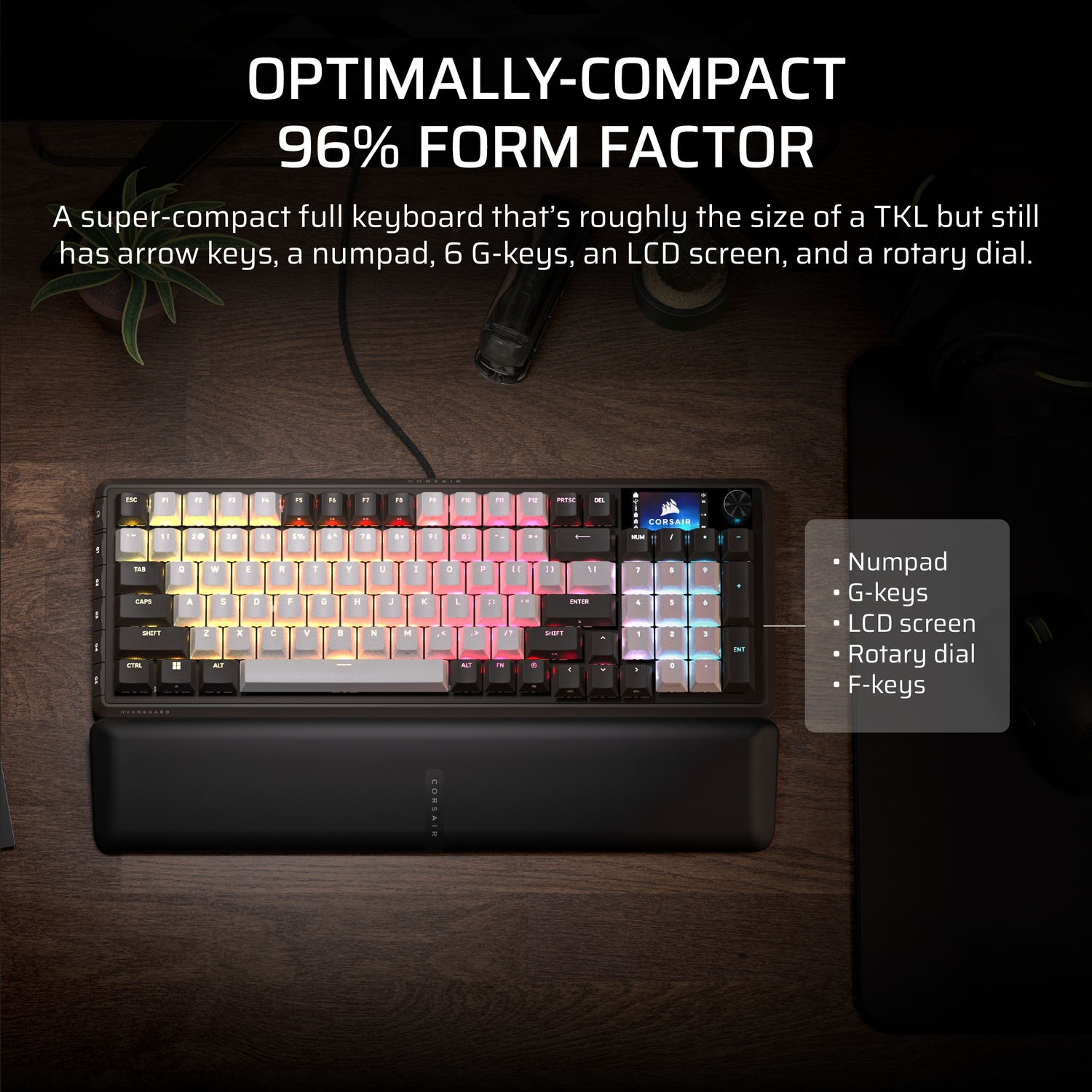 Clavier noir compact avec touches colorées, repose-poignet et petit écran. Il possède un pavé numérique et une molette rotative.