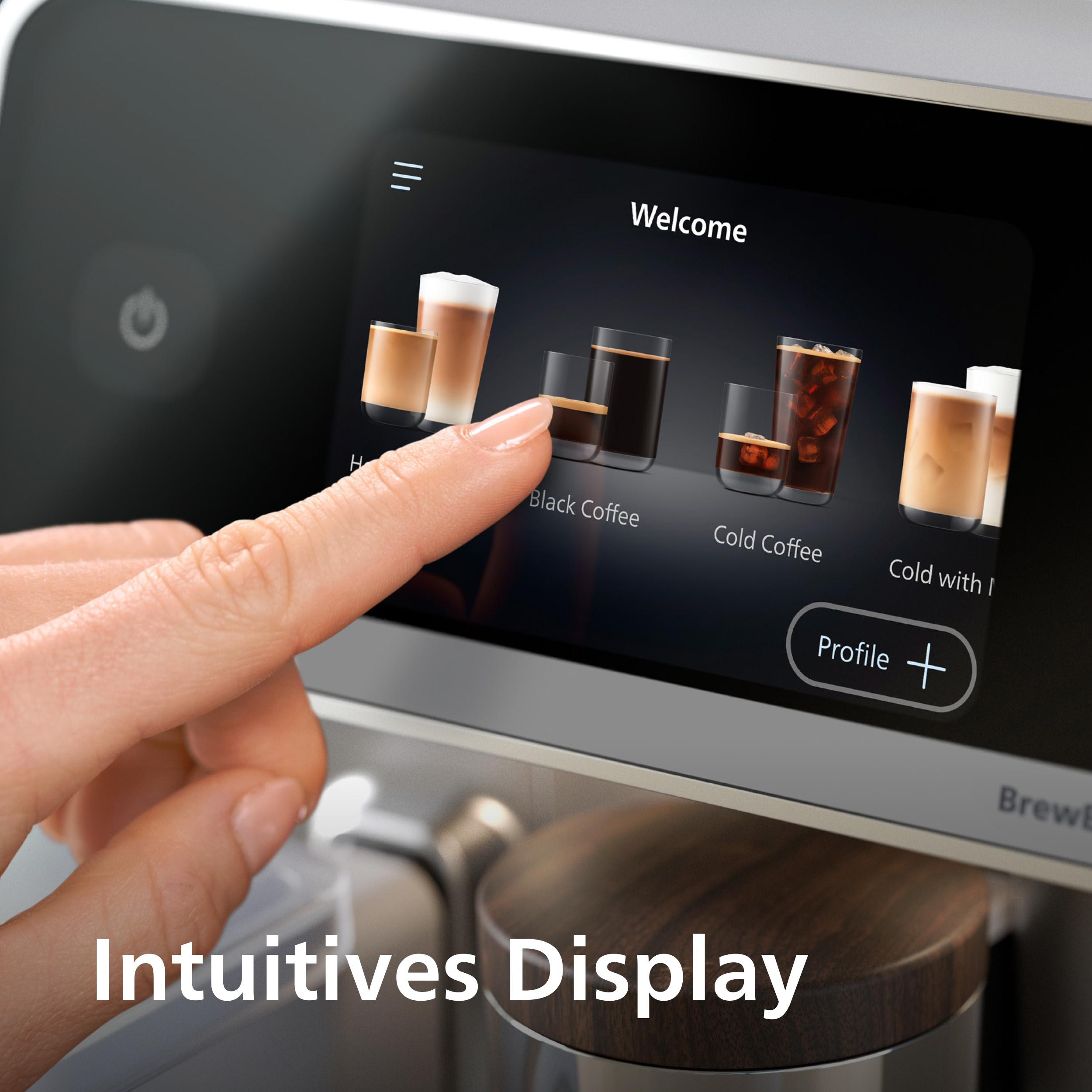 Ein Finger berührt einen Kaffeeautomatenbildschirm, auf dem Kaffeeoptionen angezeigt werden. Der Bildschirm zeigt 'Willkommen' und 'Schwarzer Kaffee'.