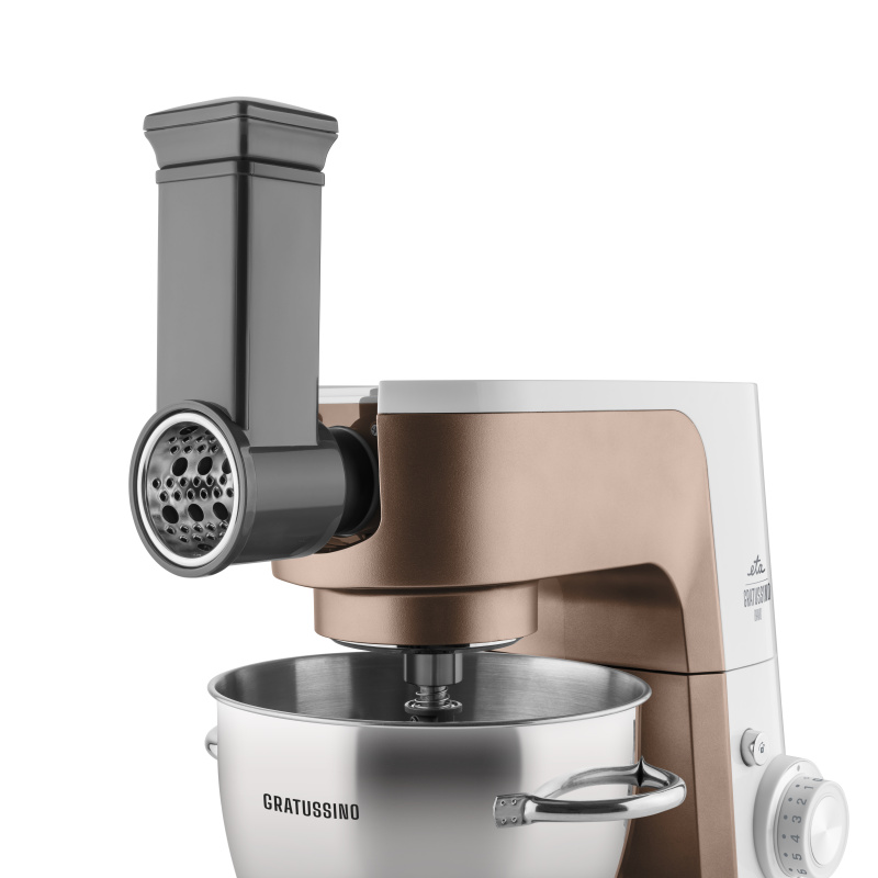 Réz és fehér konyhai mixer reszelő toldalékkal. Rozsdamentes acél tál a GRATUSSINO szóval. Gombok láthatók az oldalon.