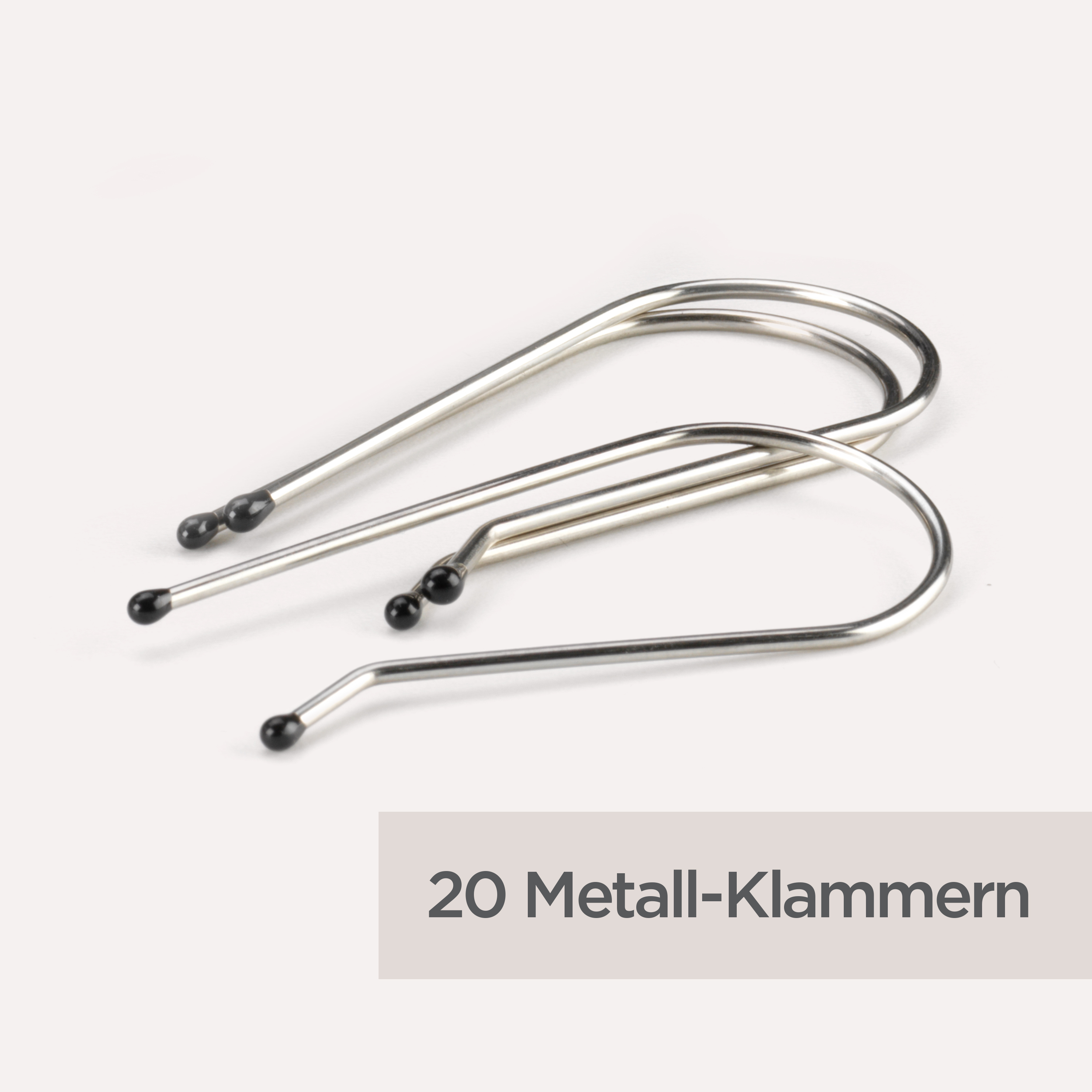 Zwei silberne Metall-Haarnadeln mit schwarzen Spitzen auf weißem Grund. Unten steht '20 Metall-Klammern'.