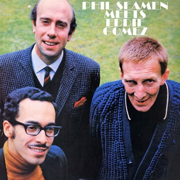 Albumcover mit drei Männern. Der Text lautet 'Phil Seamen Meets Eddie Gomez'. Die Männer lächeln und tragen Jacken und Pullover.