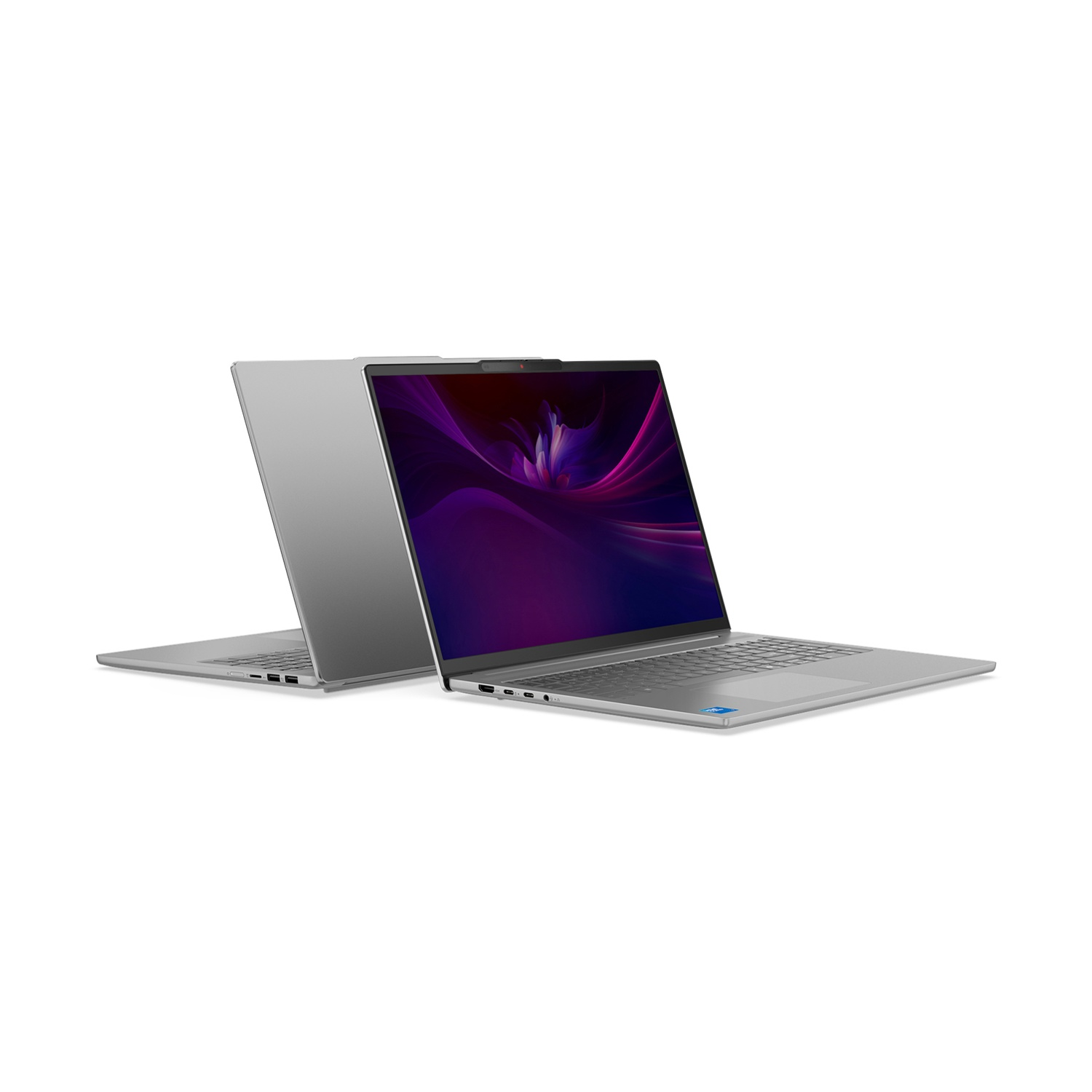 Due laptop argentati su sfondo bianco. Uno aperto, con schermo viola, l'altro chiuso.
