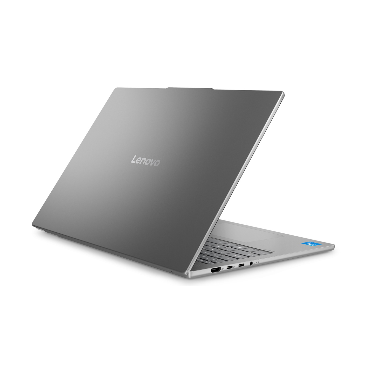 Un laptop Lenovo grigio è aperto, che mostra la tastiera e le porte. Il coperchio ha il logo Lenovo. Adesivo Intel visibile.