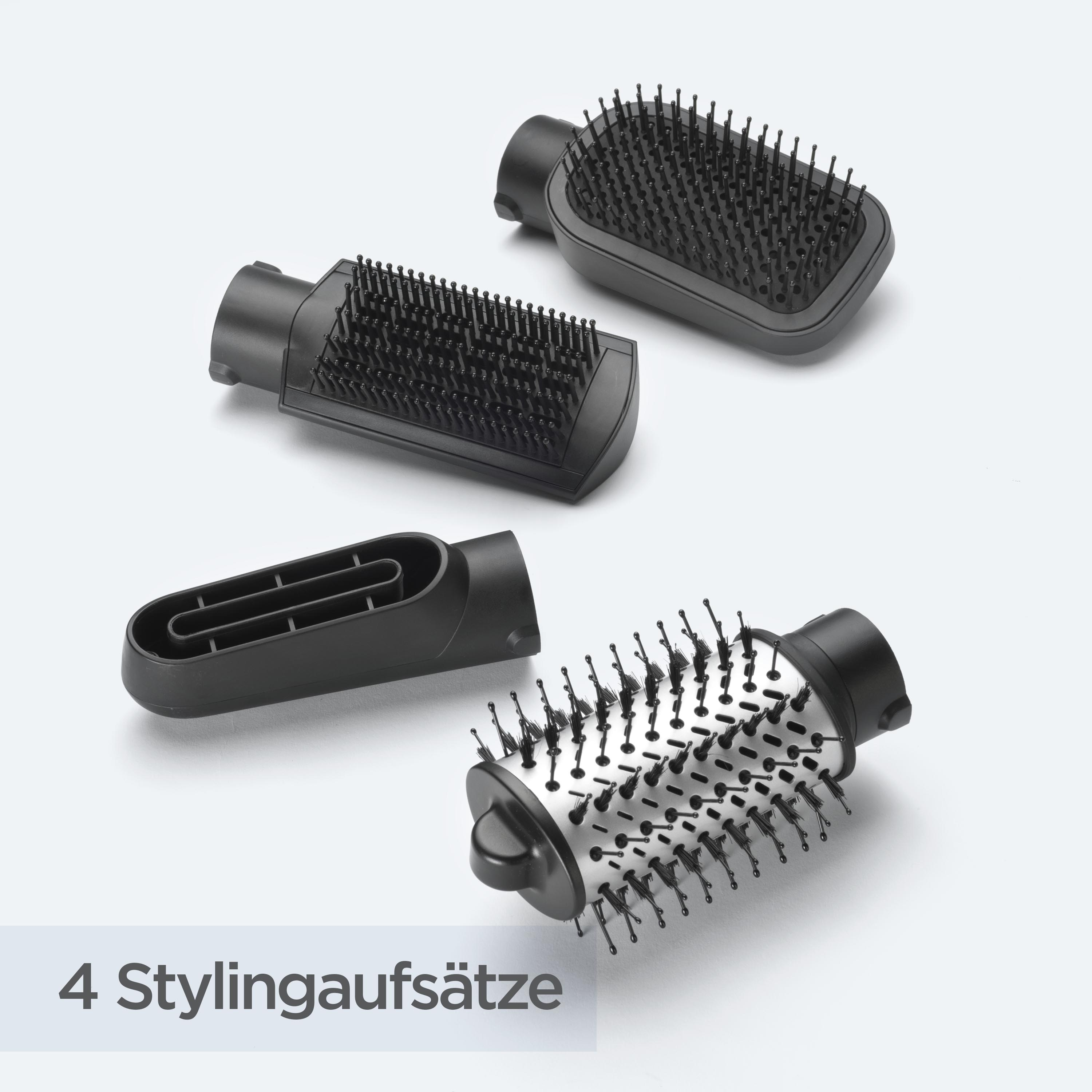 Vier schwarze Styling-Aufsätze auf weißem Untergrund, darunter Bürsten und eine Düse. Text: '4 Stylingaufsätze'.