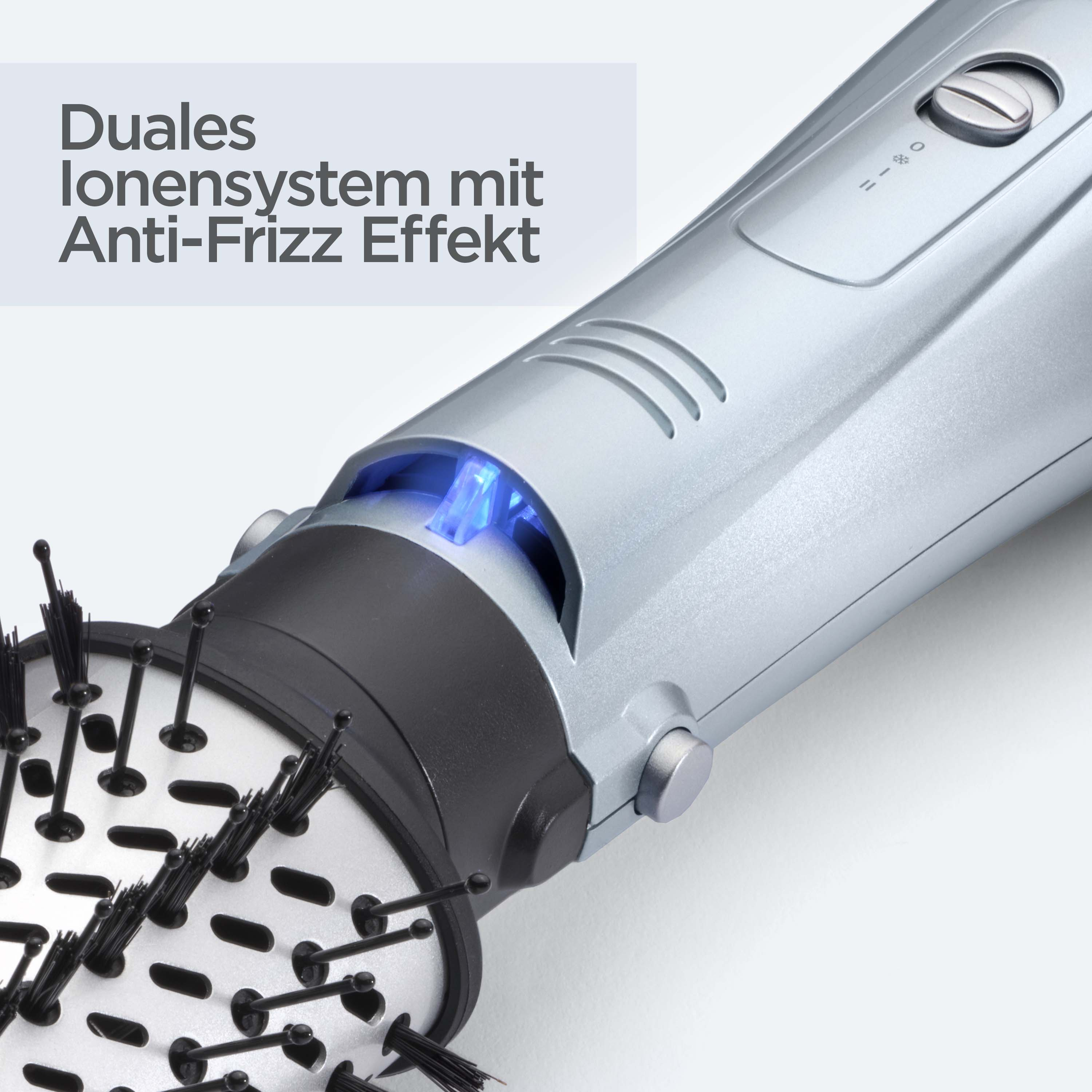 Nahaufnahme eines silbernen Haartrockners mit schwarzem Bürstenaufsatz. Text auf Deutsch ist links oben sichtbar.