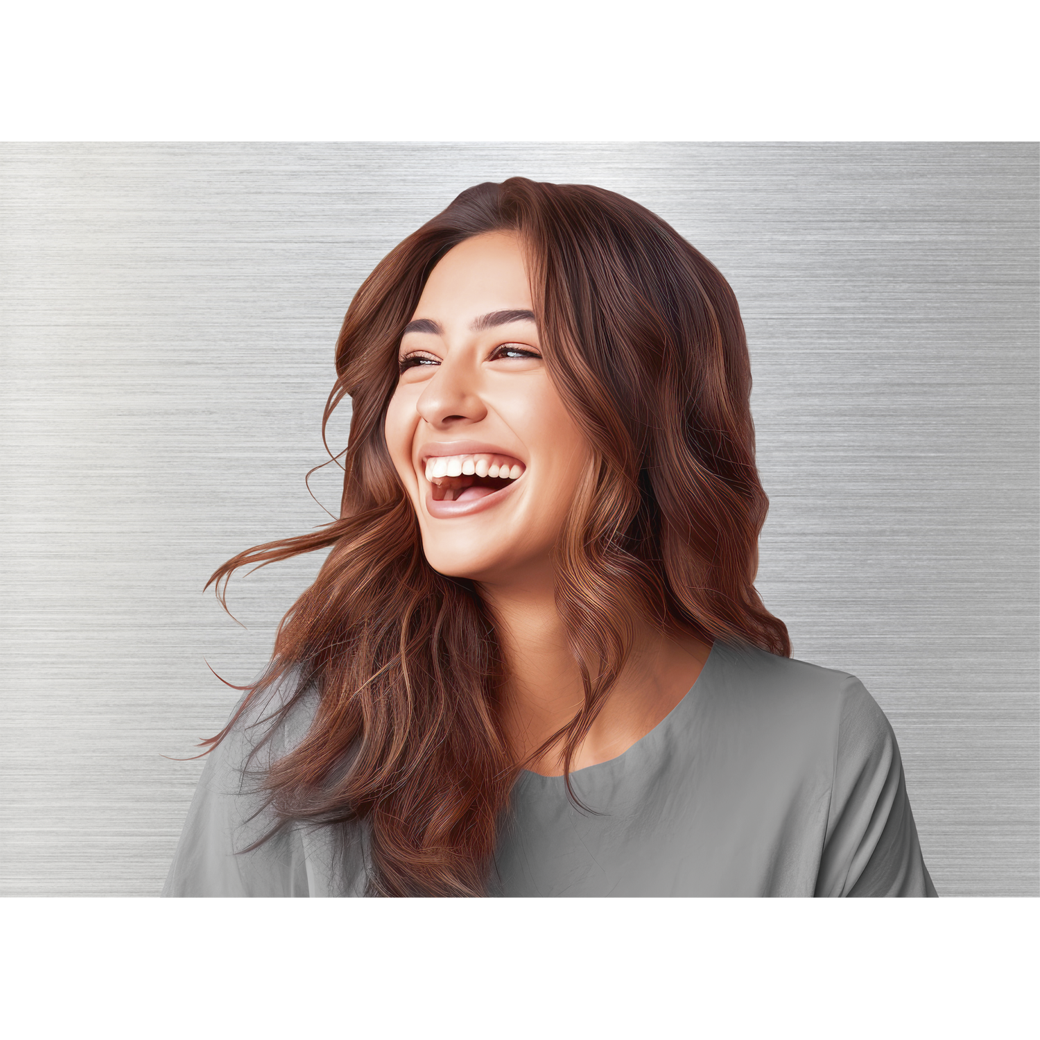 A woman with brown wavy hair smiles, laughing with her mouth open. She wears a gray top against a metallic gray background.