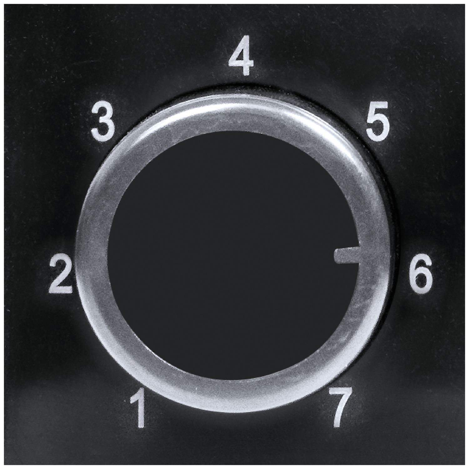 A black dial with white numbers from 1 to 7.