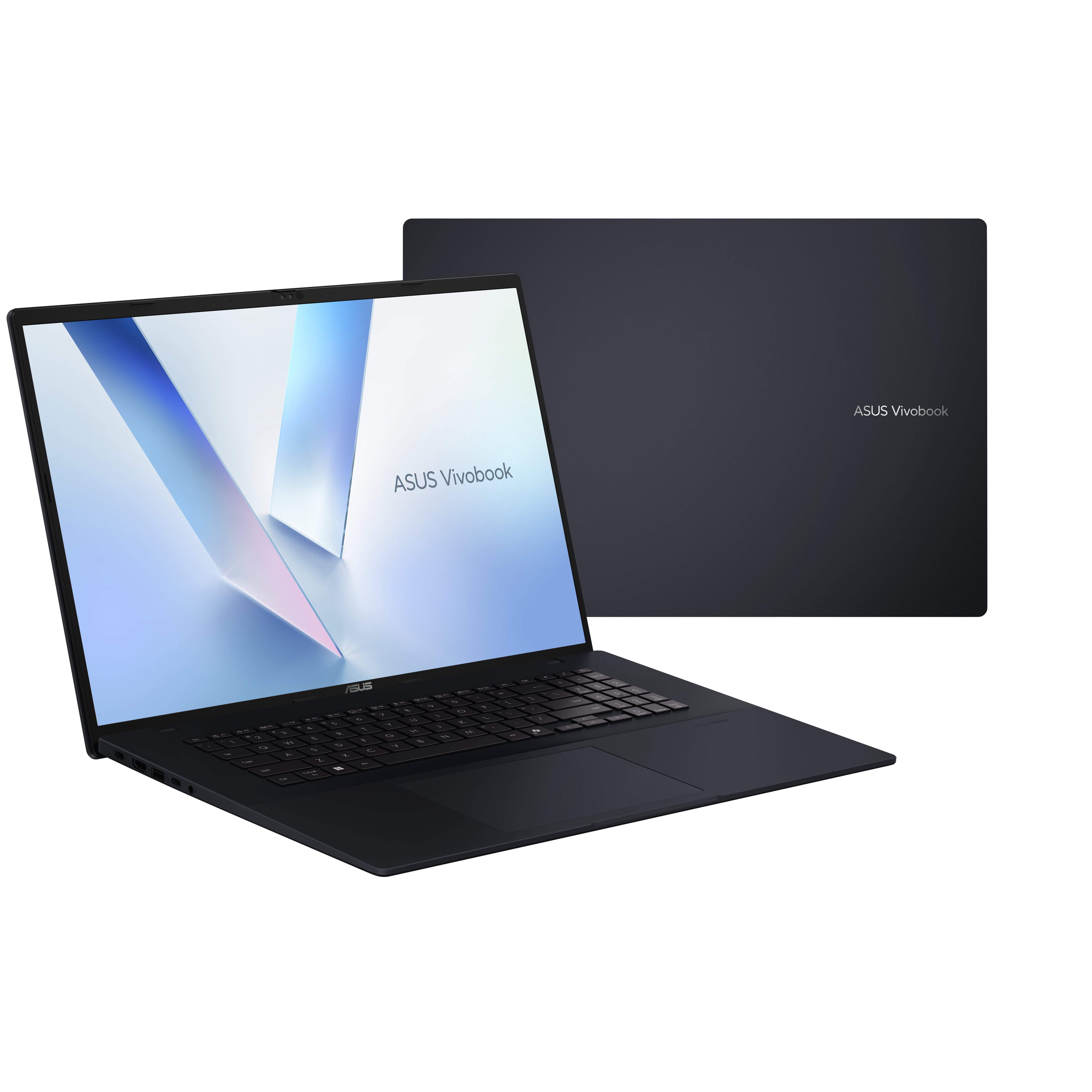 Een donkerblauwe ASUS Vivobook laptop is open, met een verlicht scherm. Er staat een andere laptop achter.