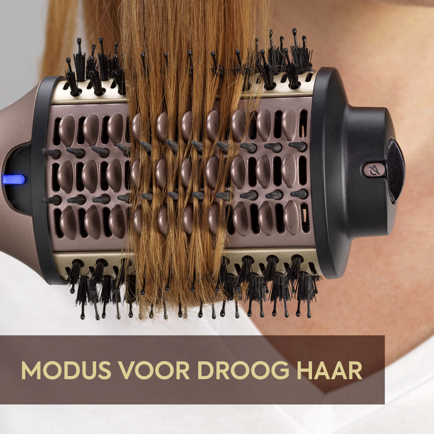 A woman's hair is being styled with a hair dryer brush. The brush is brown and black, and the hair is light brown.