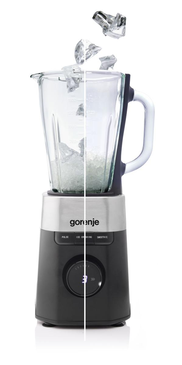 Ein Mixer mit Eiswürfeln, die in das Glas fallen. Der Mixer ist schwarz und silber, mit dem Markennamen Gorenje.