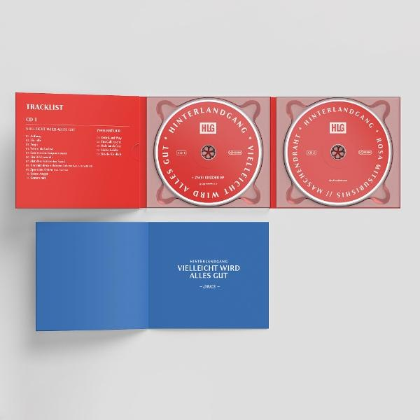 Offene CD-Hülle mit zwei roten CDs. Trackliste links, Songtextbuch darunter. Albumtitel und Künstler sichtbar.