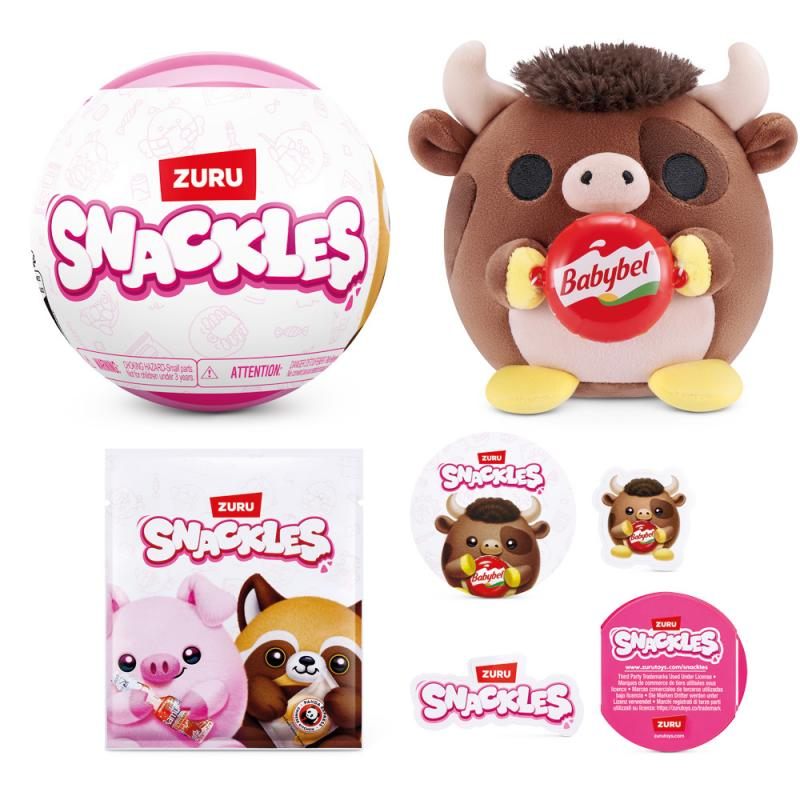 Ein rosa-weißer ZURU Snackles-Ball, ein Stoffbulle mit einem Babybel und Snackles-Aufklebern und -Verpackungen.