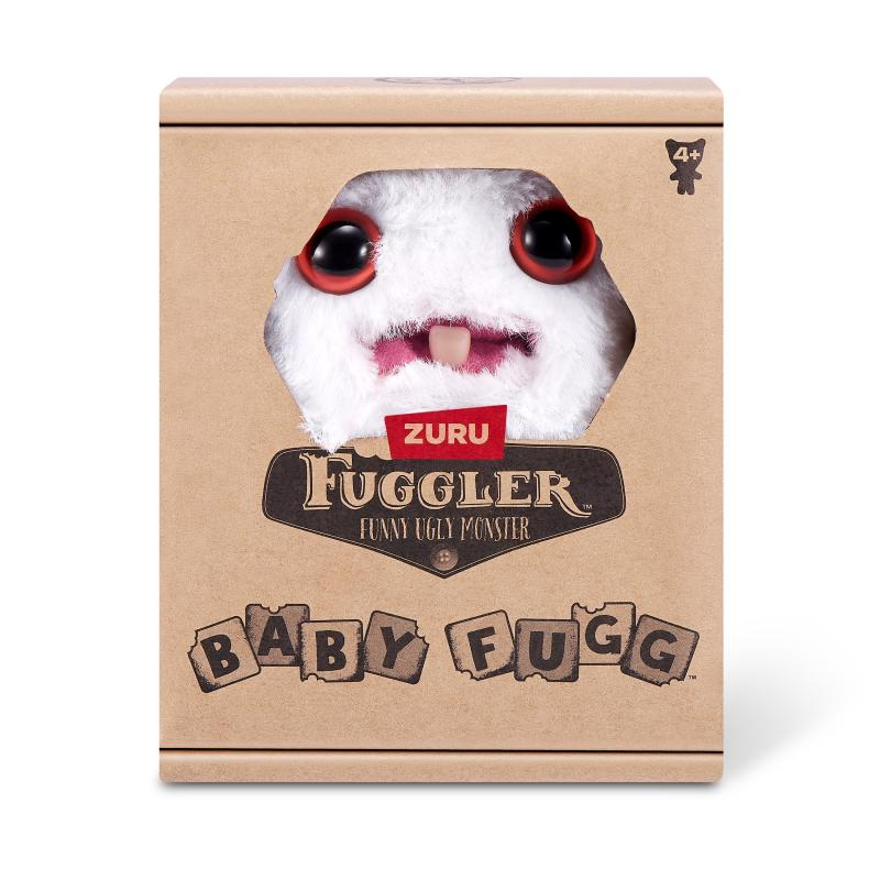 Ein Baby-Fuggler-Spielzeug in einer Box. Der Fuggler ist weiß mit rot umrandeten Augen und einem einzelnen Zahn. Auf der Box steht 'Funny Ugly Monster'.