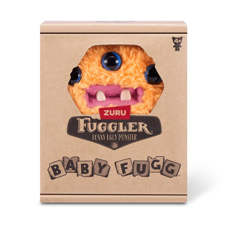 Ein Fuggler-Spielzeug in einer Schachtel. Das Spielzeug ist orange, hat blaue Augen und einen rosa Mund. Die Schachtel ist braun und hat den Namen des Spielzeugs.