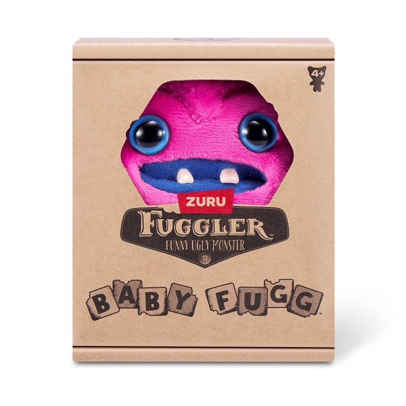 Ein Fuggler-Spielzeug in einer Schachtel. Das Monster ist rosa mit blauen Augen und einem blauen Mund. Die Schachtel ist braun mit Text.