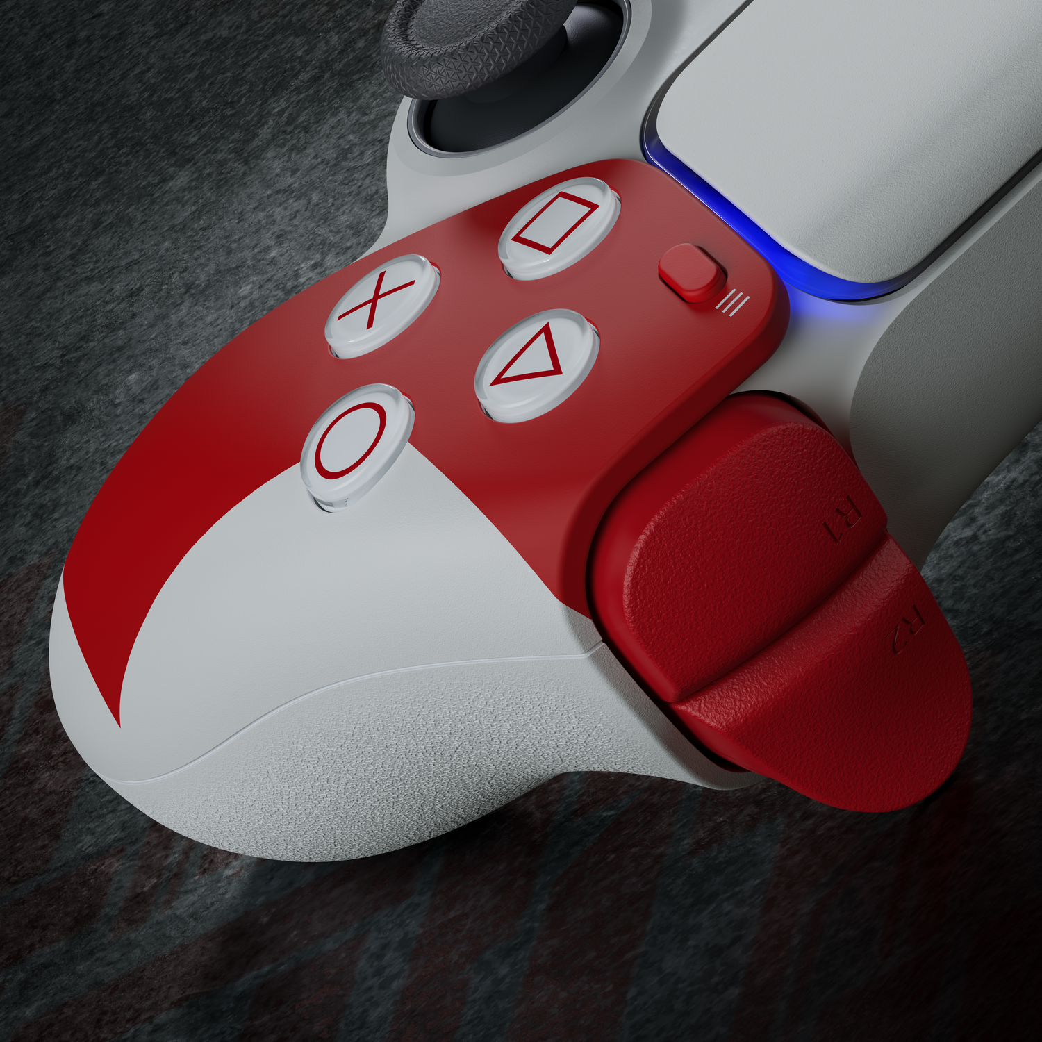 Primer plano de un mando de juego blanco y rojo. Los botones muestran símbolos. El fondo es una superficie oscura y texturizada.