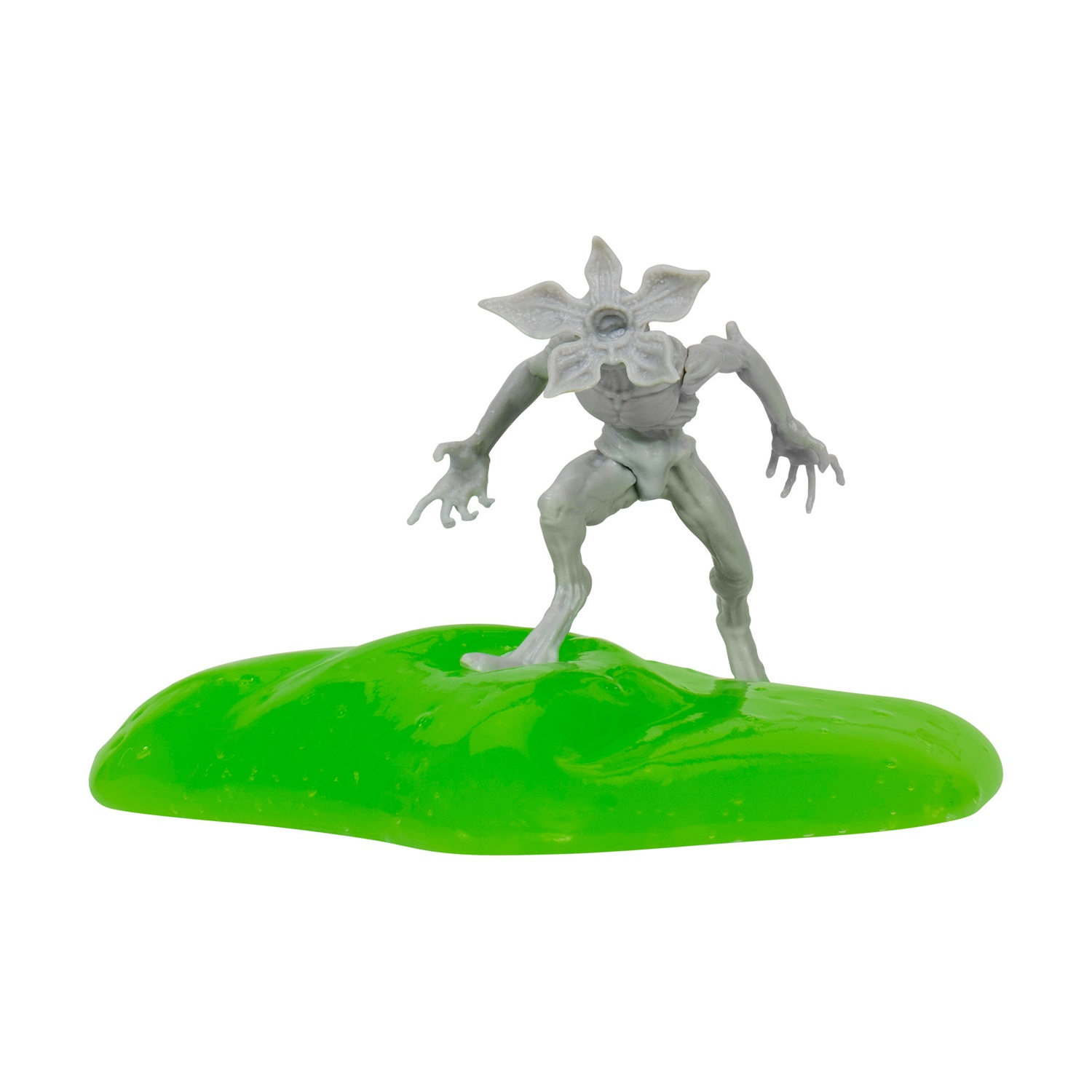 Un giocattolo grigio di Demogorgon è in piedi su una base verde a forma di goccia contro uno sfondo bianco. Ha una testa a forma di fiore e mani artigliate.