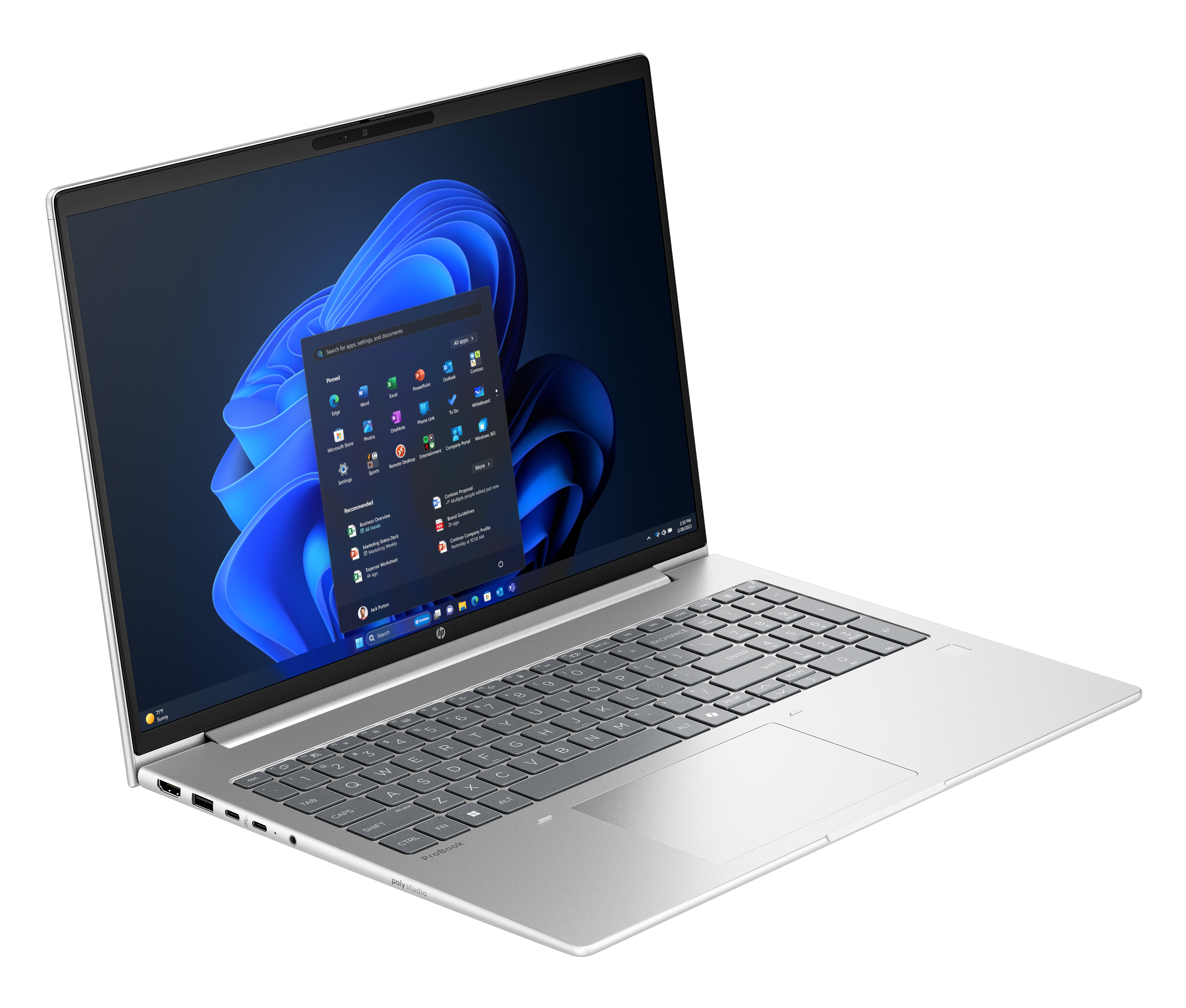 Ordinateur portable argenté ouvert sur une surface blanche, affichant l'interface Windows 11. Clavier visible. Fond bleu et noir.