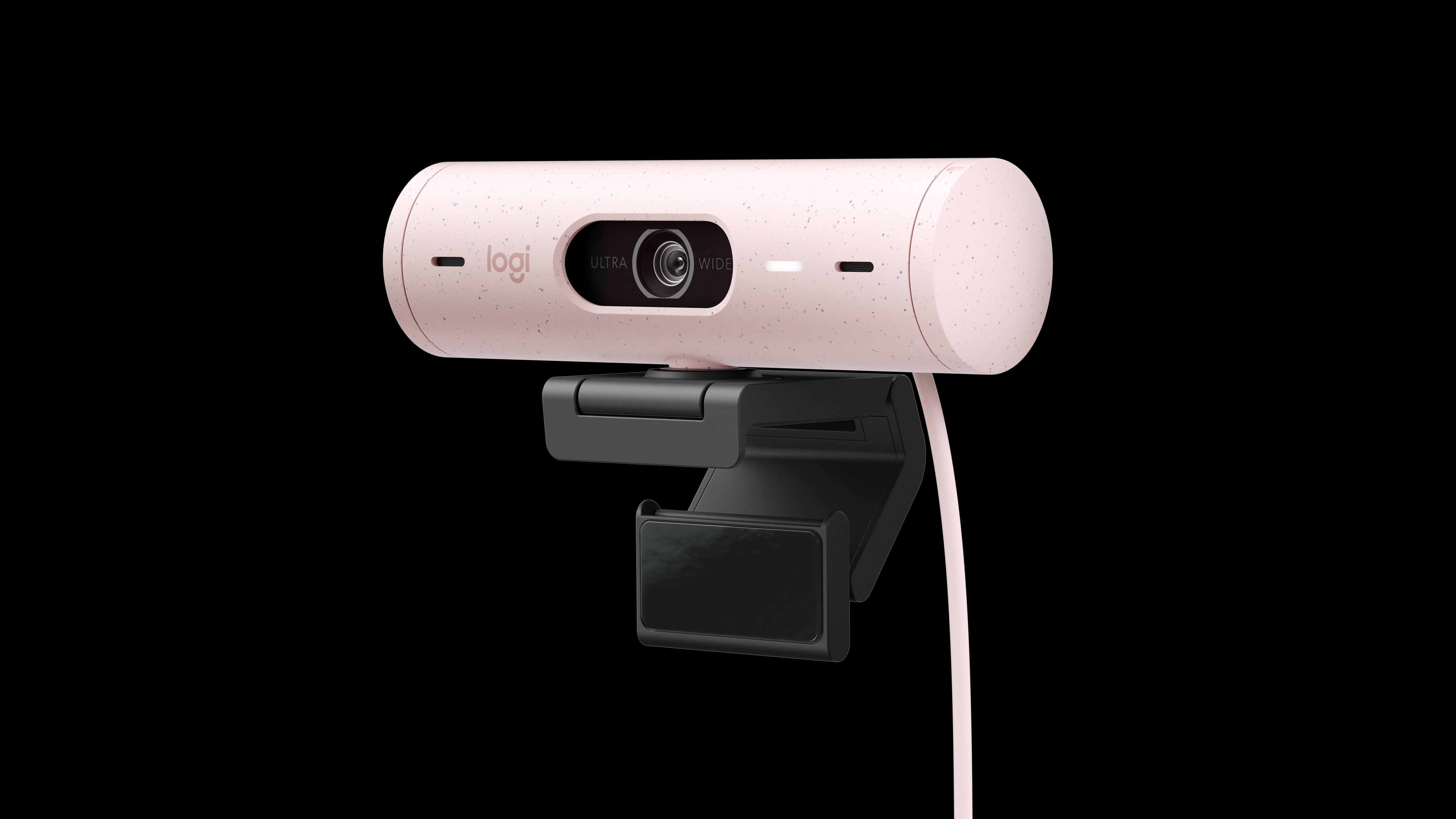 Eine hellrosa gesprenkelte Webcam mit schwarzer Halterung. Sie hat 'logi', 'ULTRA' und 'WIDE' aufgedruckt. Schwarzer Hintergrund.