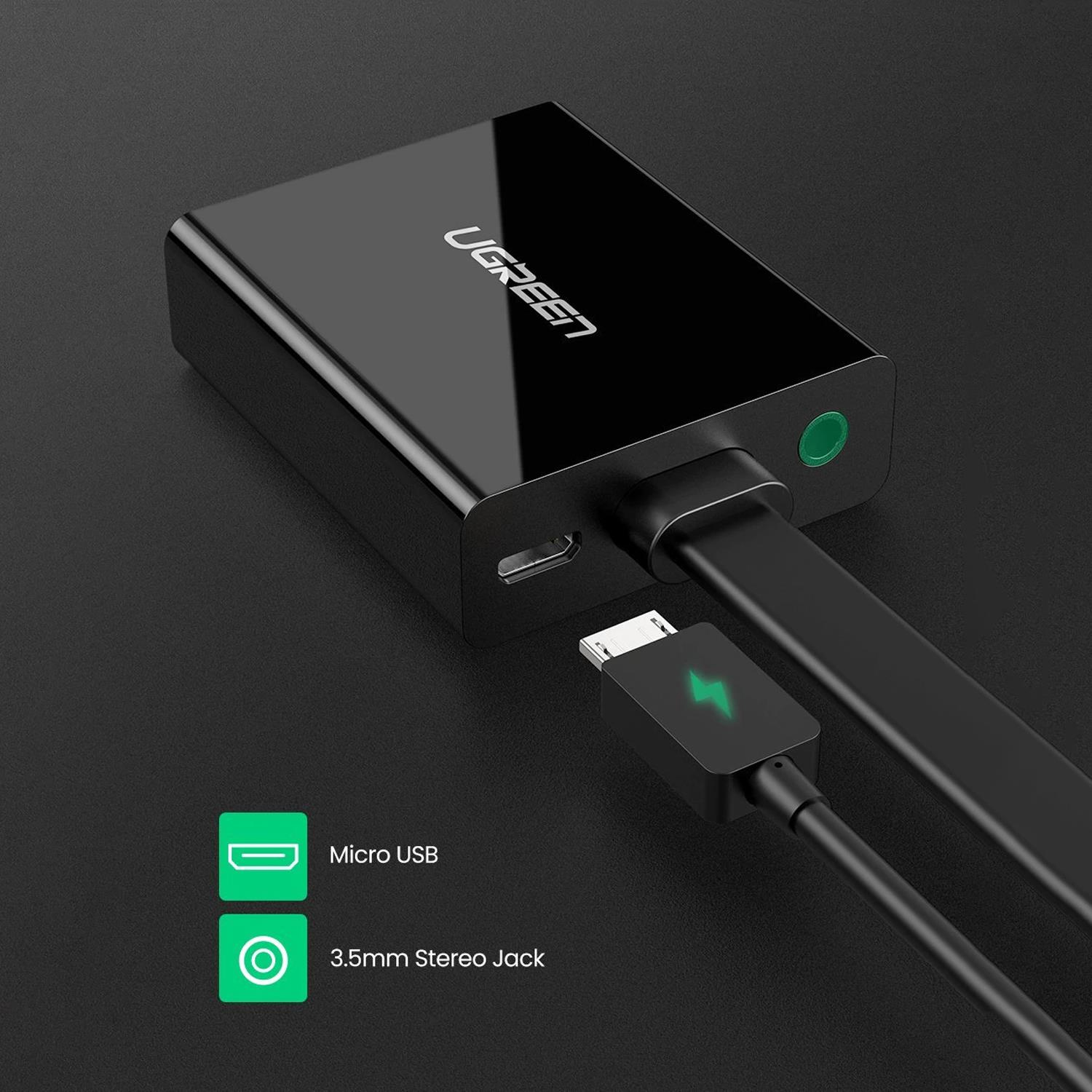 Siyah UGREEN cihazı, kablo bağlı. Micro USB ve 3,5 mm stereo jak simgeleri sol altta. Yeşil bir şimşek belirgin.